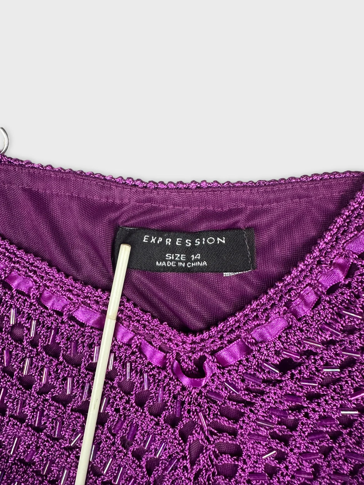 Detail view of purple upper body shorts with a textured lace design.