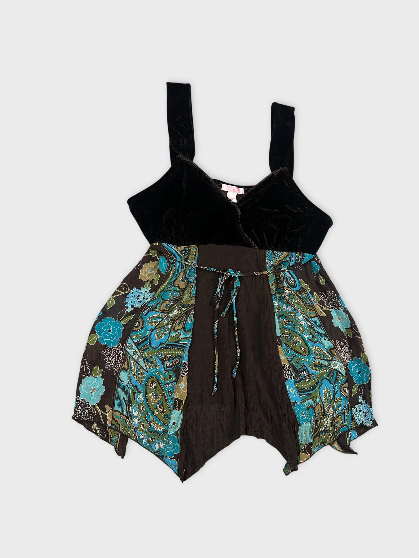 Detail view of women's upper body shorts in black with floral pattern.
