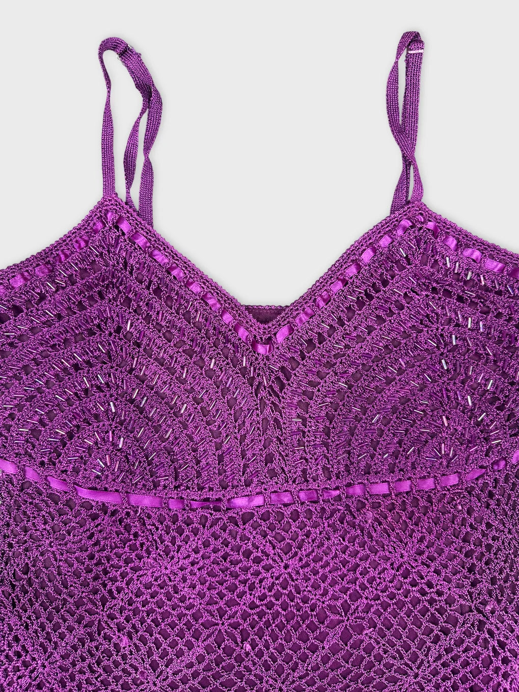 Detail view of a purple upper body shorts with intricate lace details.