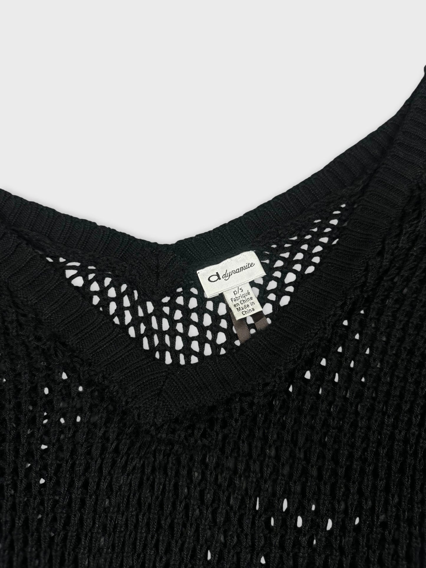 detail view of a black knitted top with a V-neck design