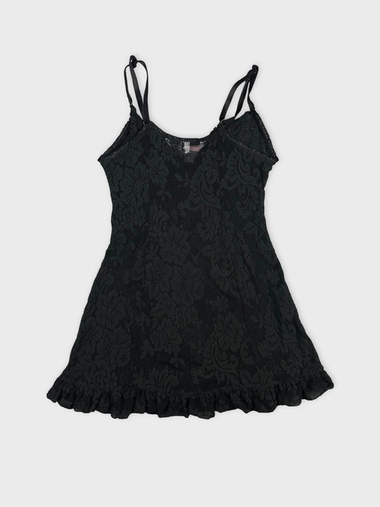 Back view of a black vintage lace top with ruffled hem