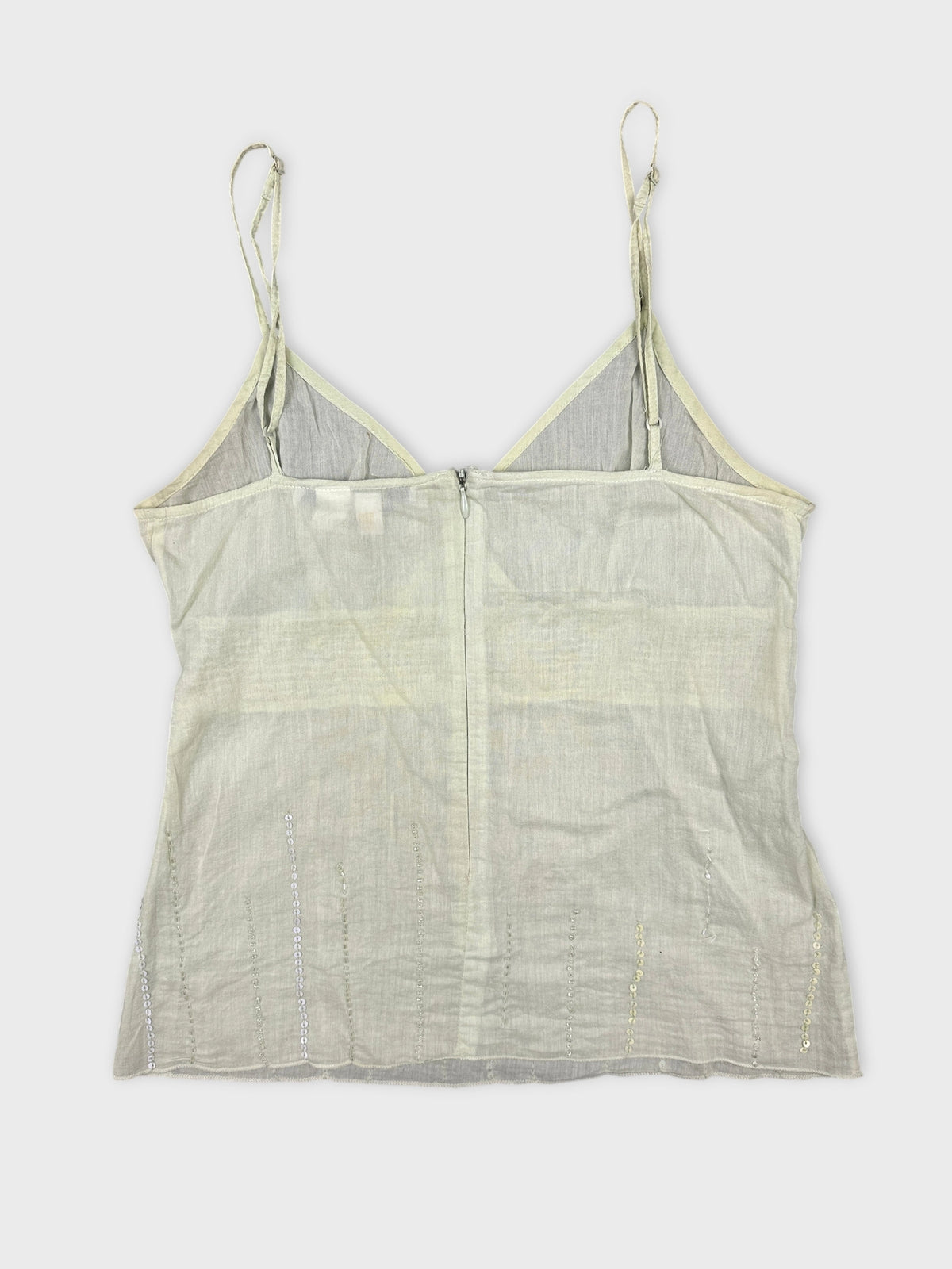 Back view of a light green sleeveless top with sequined detail.