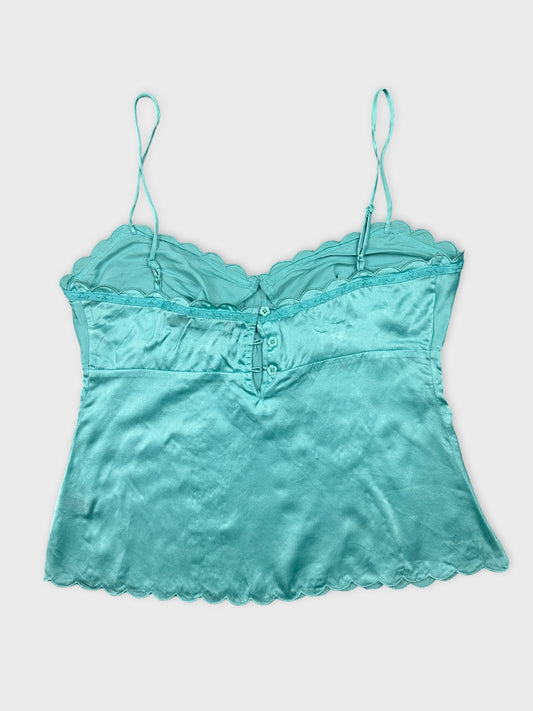 Back view of a turquoise camisole with scalloped hem and adjustable straps.