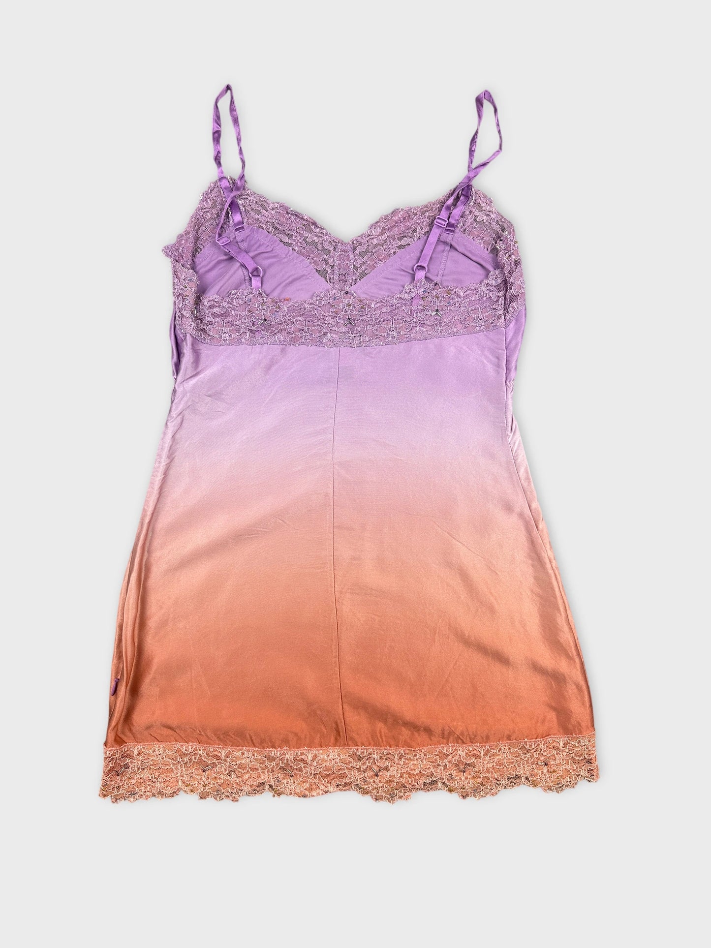 Back view of a purple and orange ombre lace-trimmed camisole top.