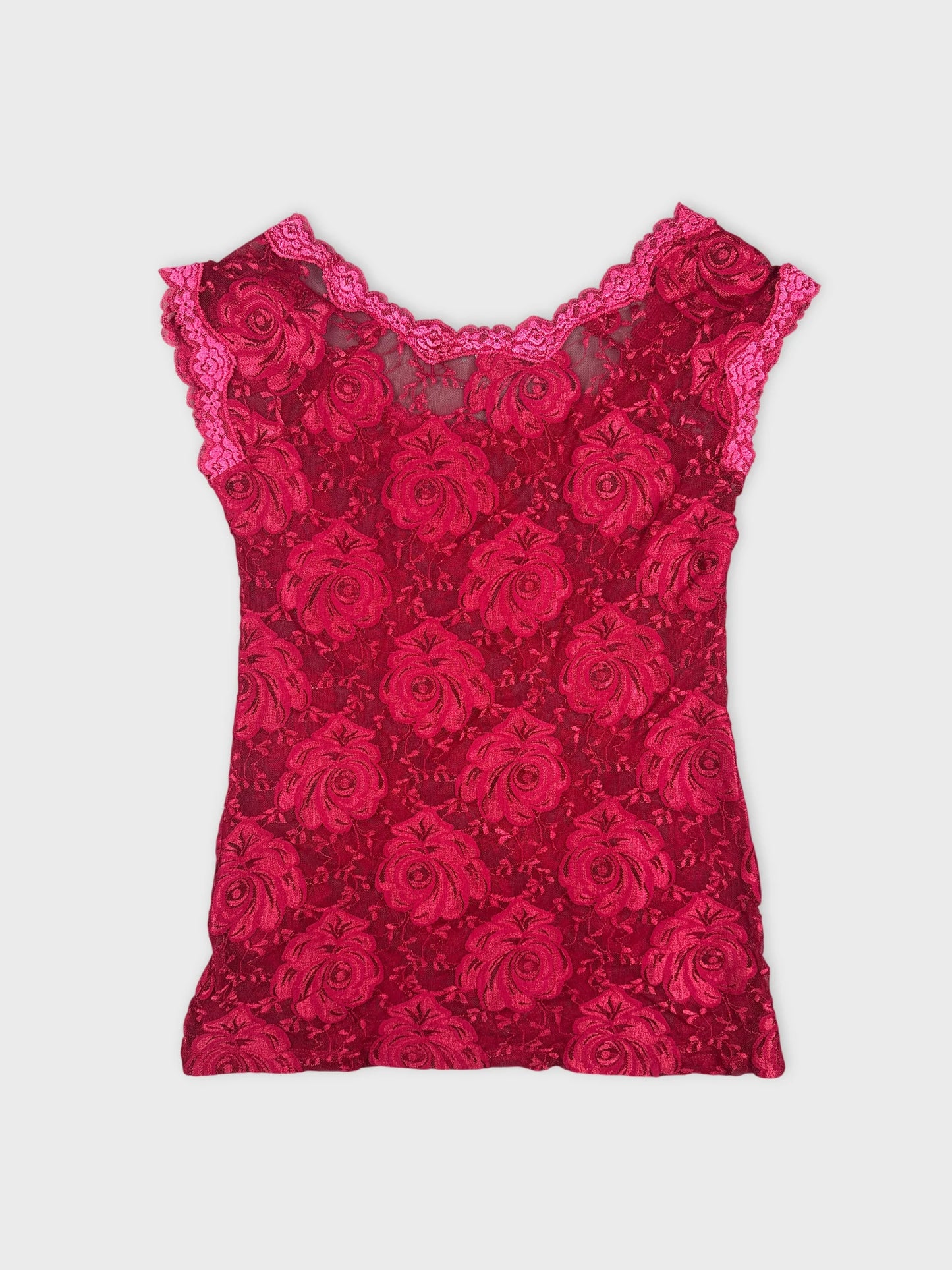 Back view of a red floral lace top featuring scalloped trim.