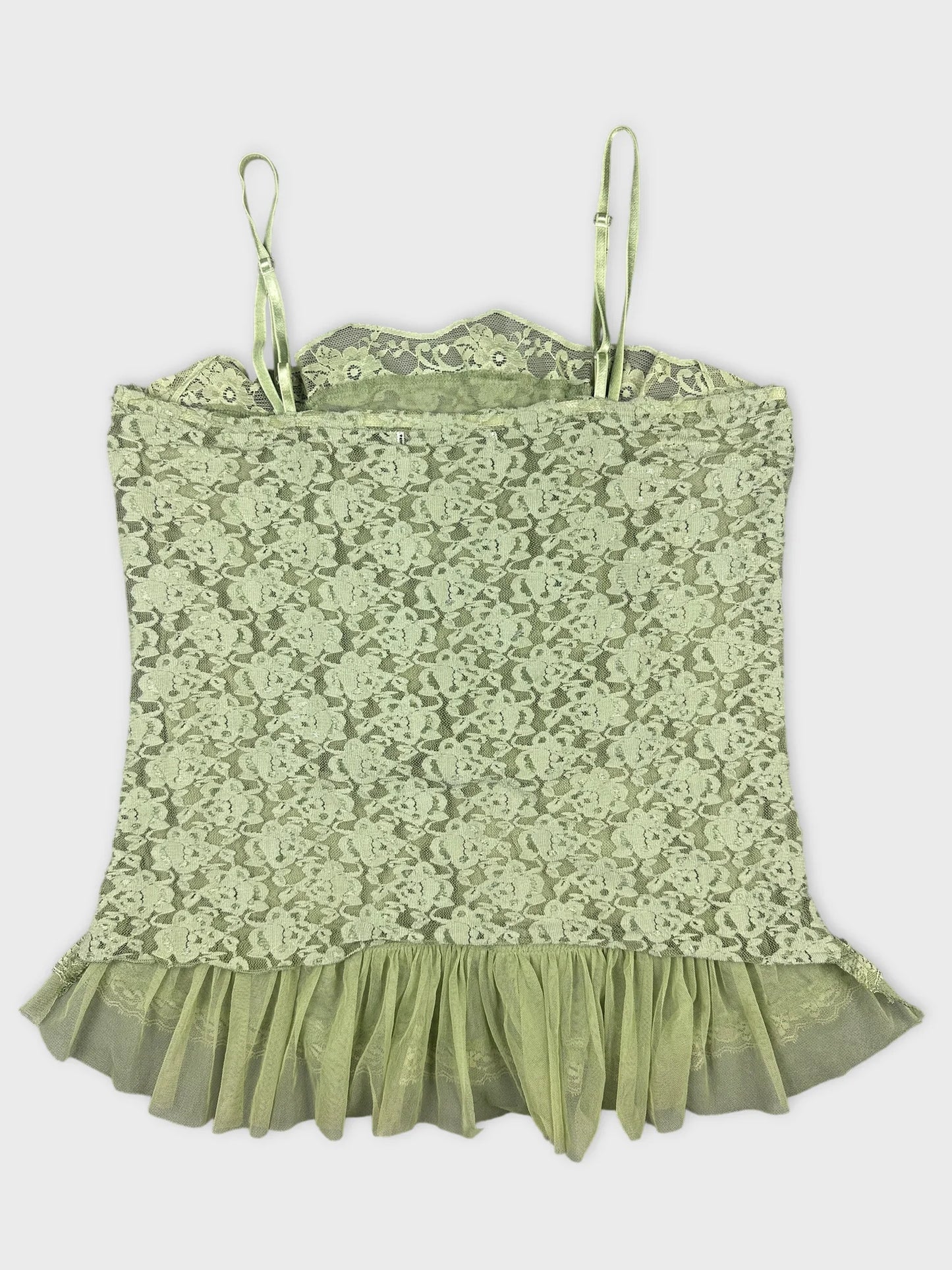 Back view of a light green lace top with ruffled hem.