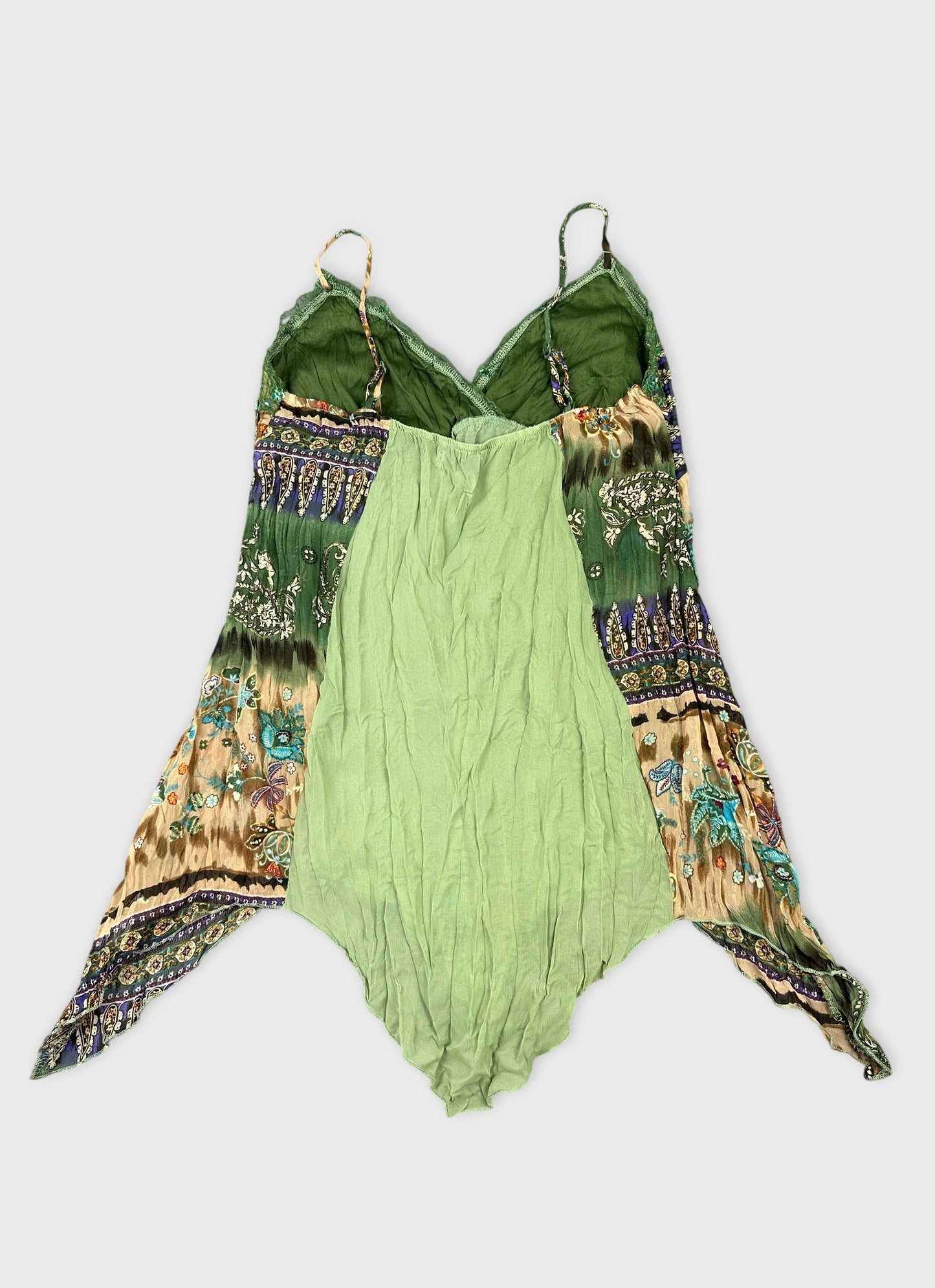 Back view of a green vintage top featuring a patterned hem and thin straps.