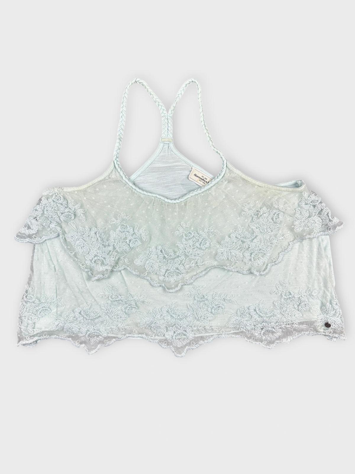 Back view of a light blue cropped top with lace trim.
