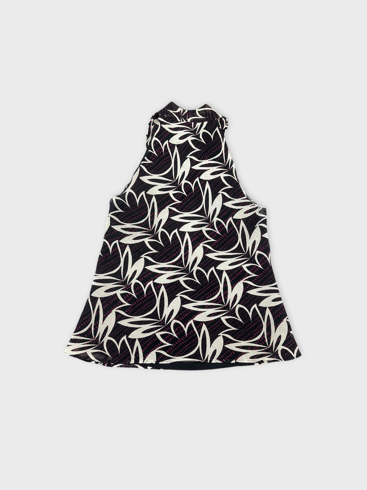 Back view of a women's sleeveless top in black with white floral pattern.