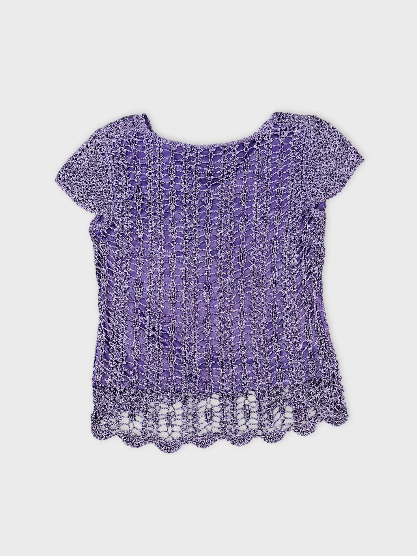 Back view of a purple lace top with a scalloped hem.