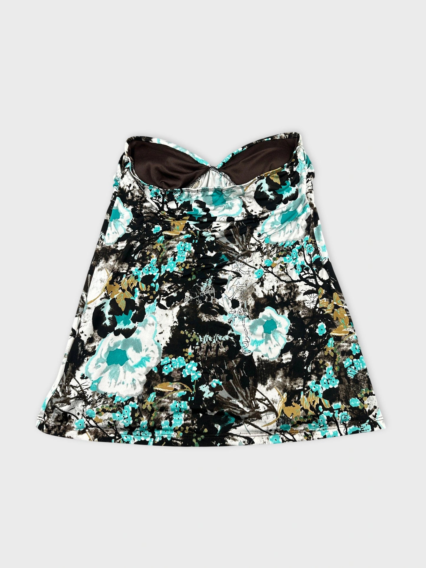 Back view of a vintage women's top in dark floral print.