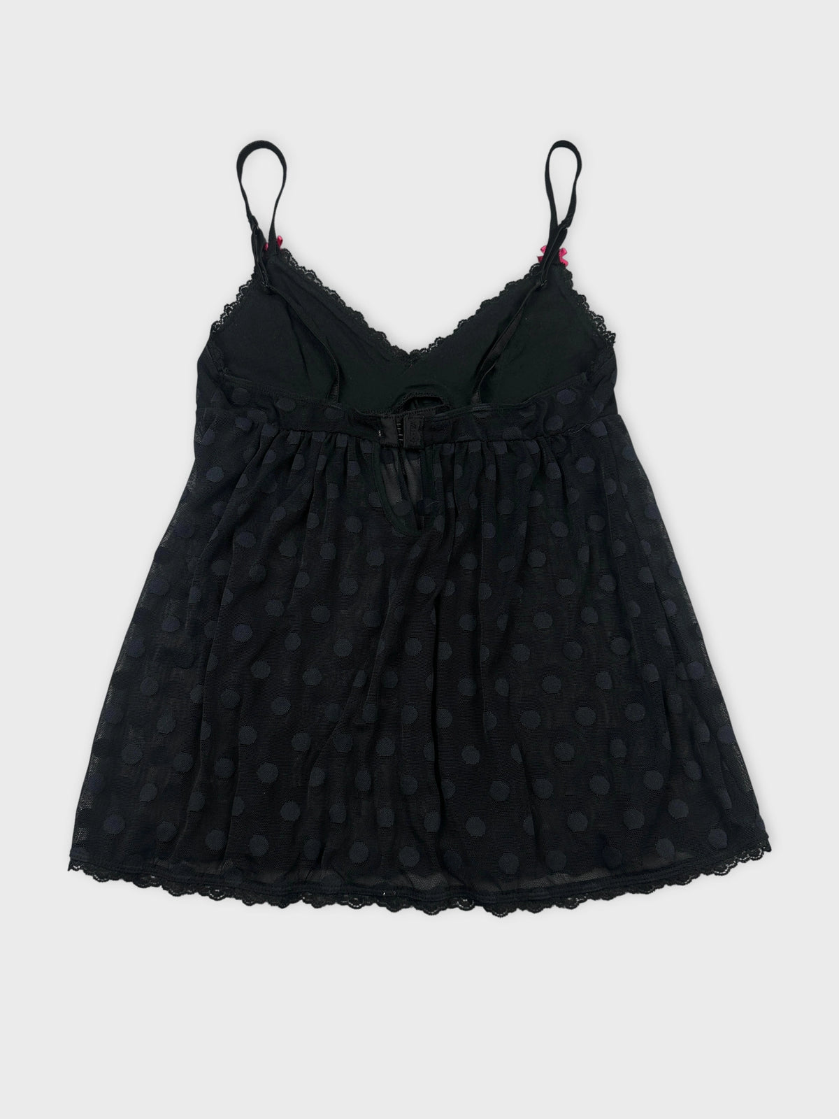 Black women’s top with polka dot pattern back view