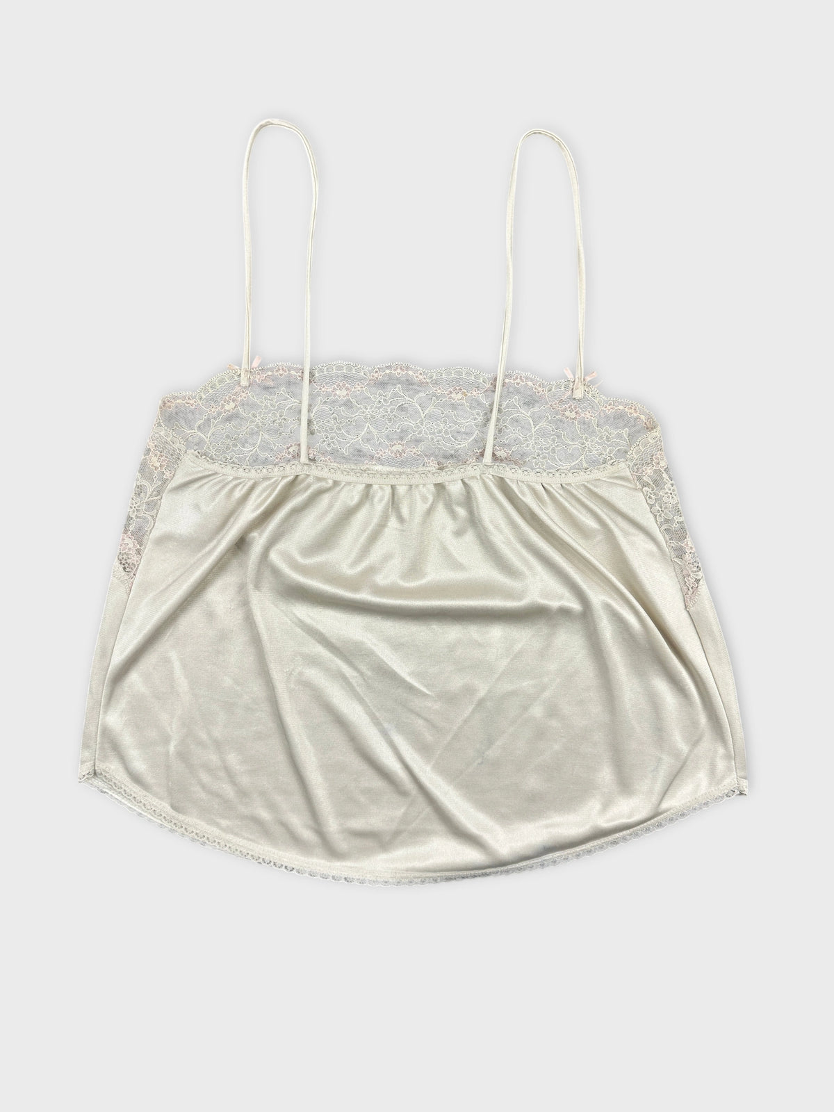 Back view of a cream lace-trimmed camisole top.