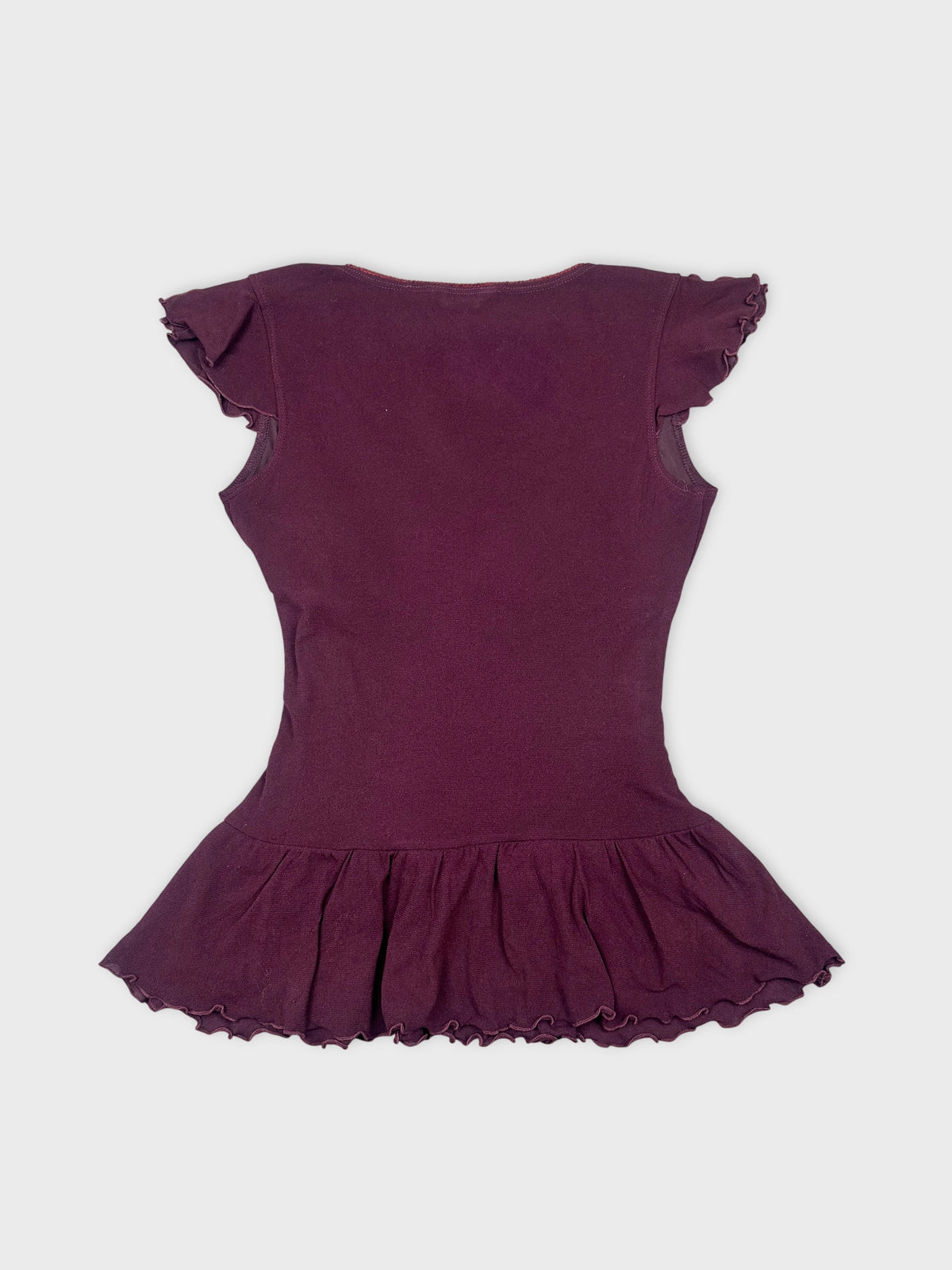 Back view of a purple ruffled hem top for women.