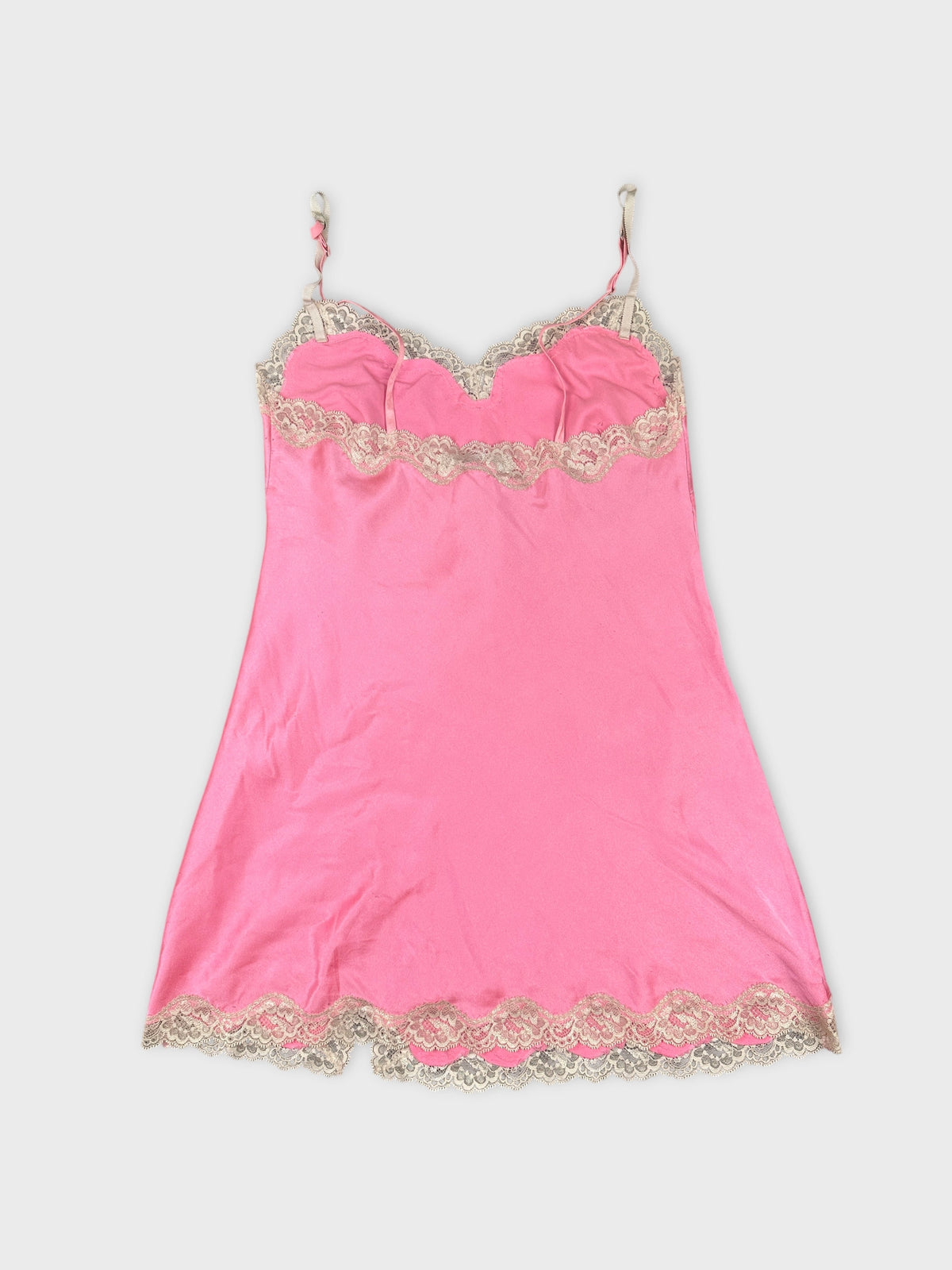 Back view of a pink vintage top with lace trim details.