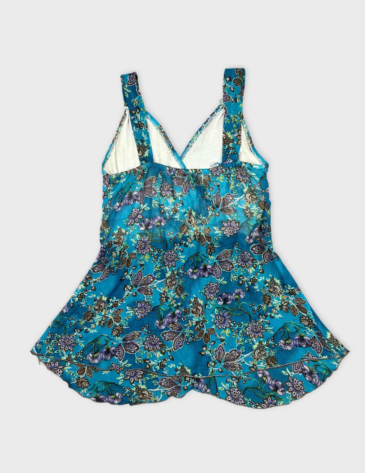 Back view of a turquoise floral women's top with adjustable straps.