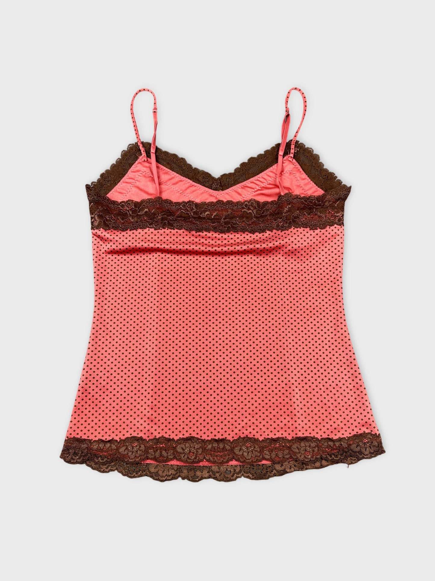 Back view of a pink polka dot camisole with brown lace trim.