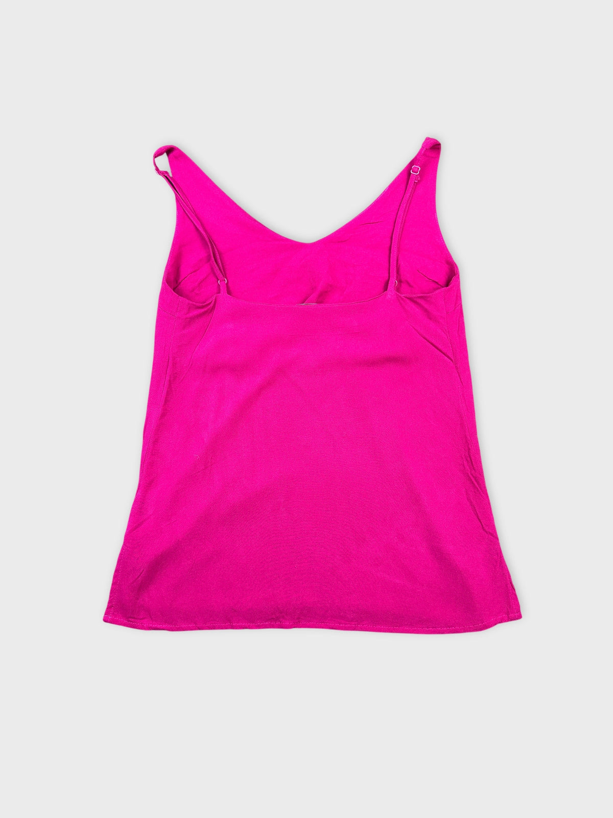 Back view of a bright pink women's tank top with a simple design.