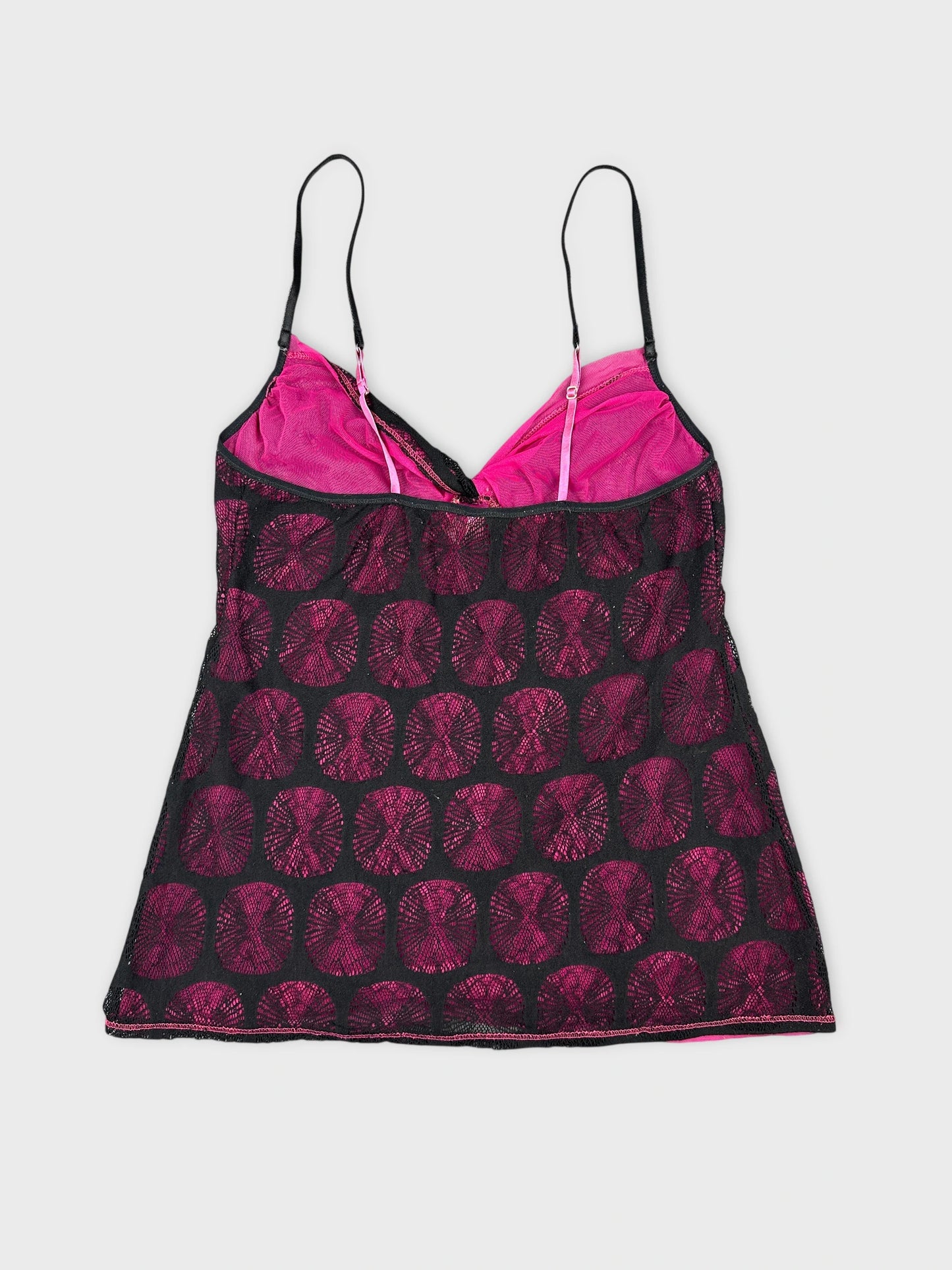 Back view of a black and pink camisole with circular patterns.