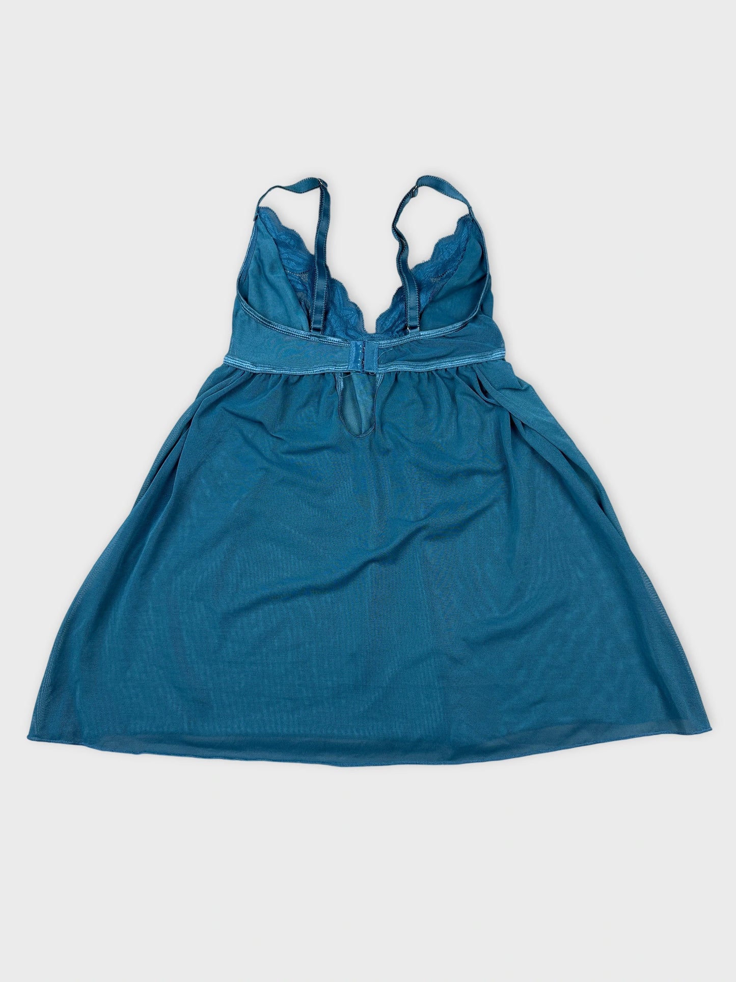 Back view of a teal upper body top with lace trim details.