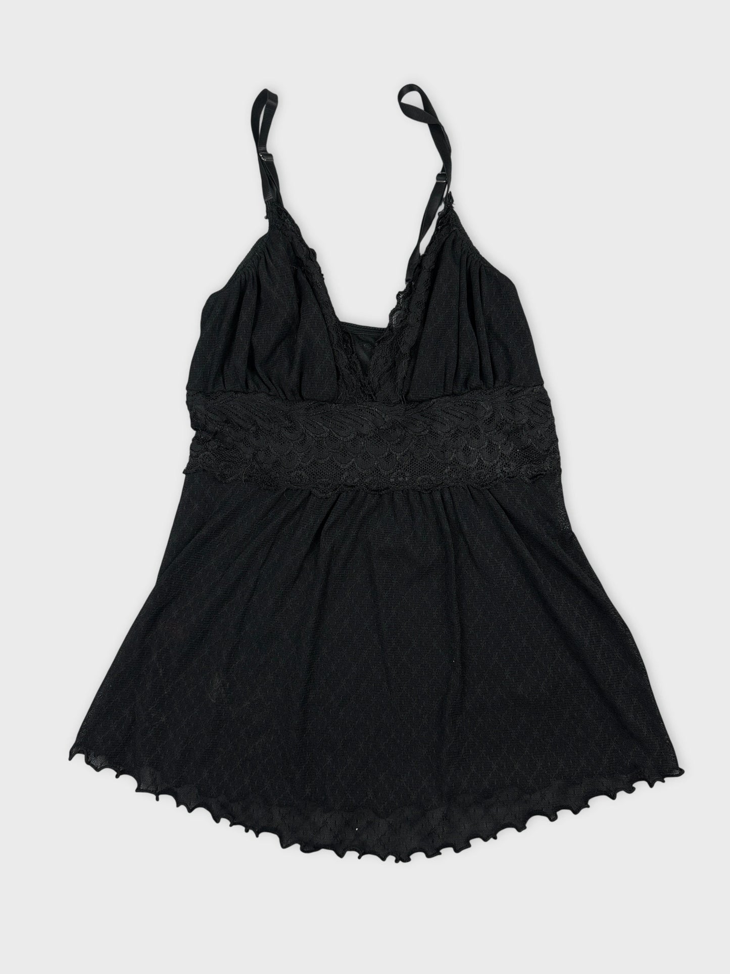 Back view of a black vintage top featuring lace trim and spaghetti straps.