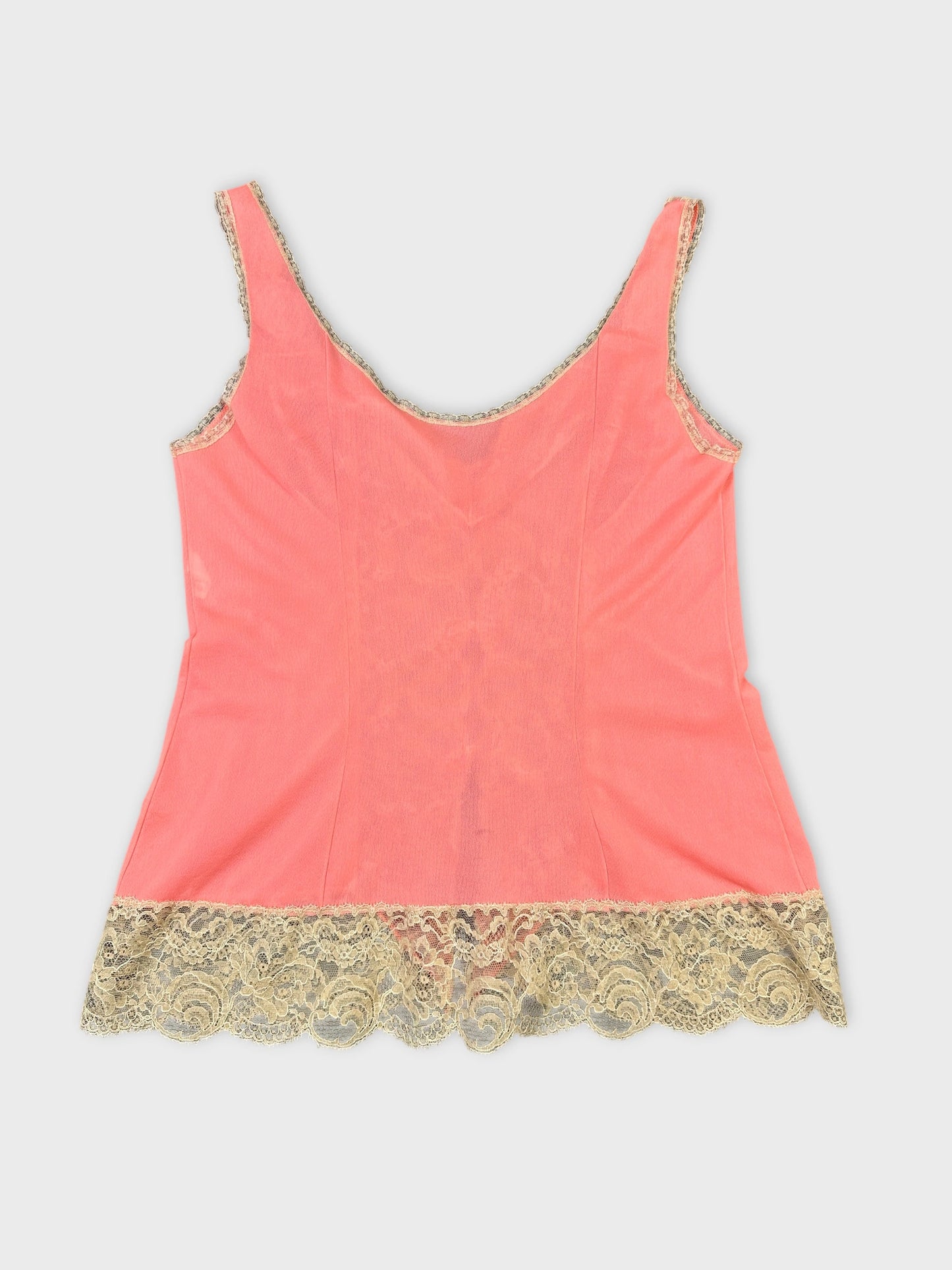 Back view of a coral women's top with lace trim at the hem.
