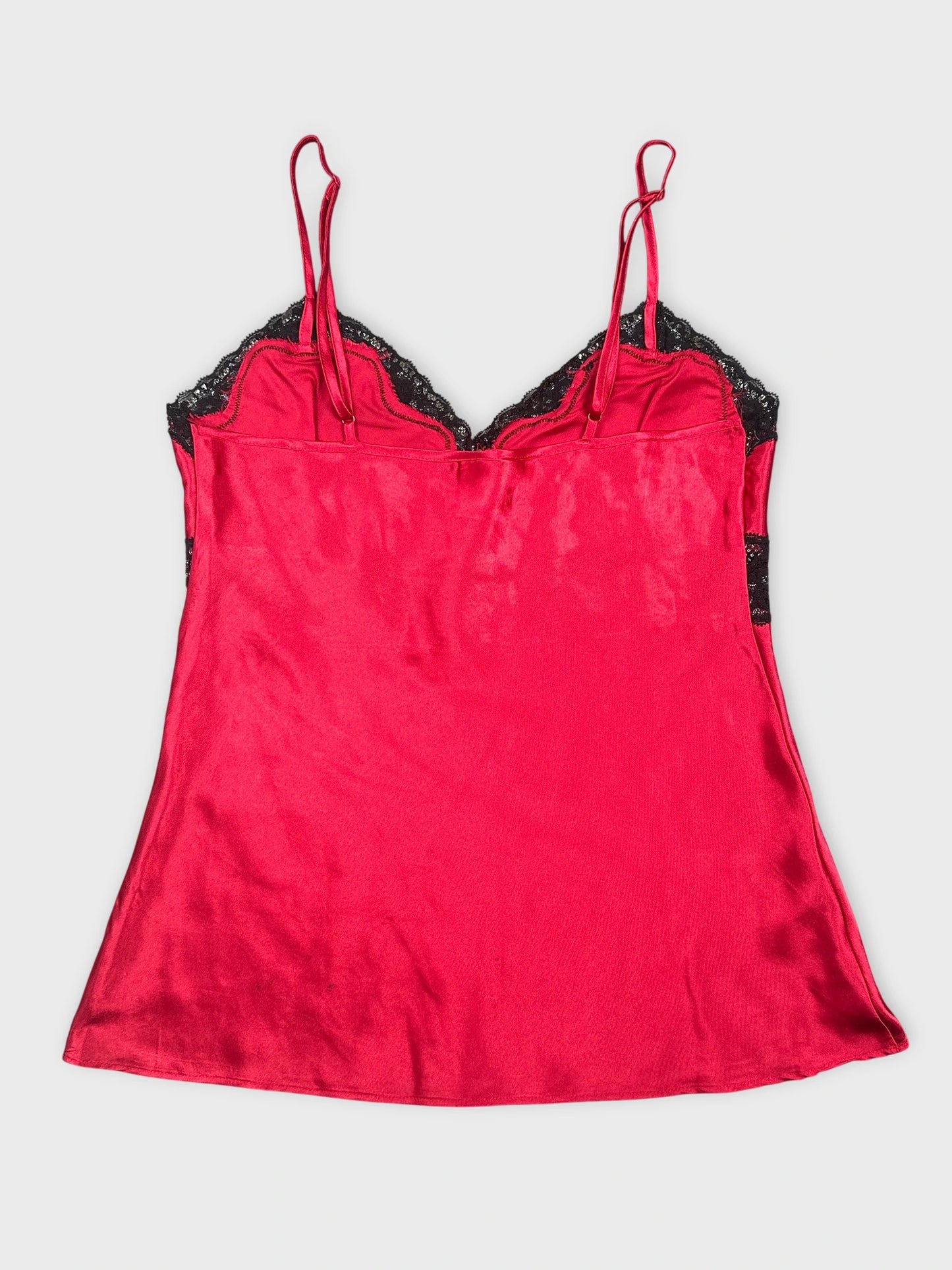 Back view of a red satin camisole with black lace trim.
