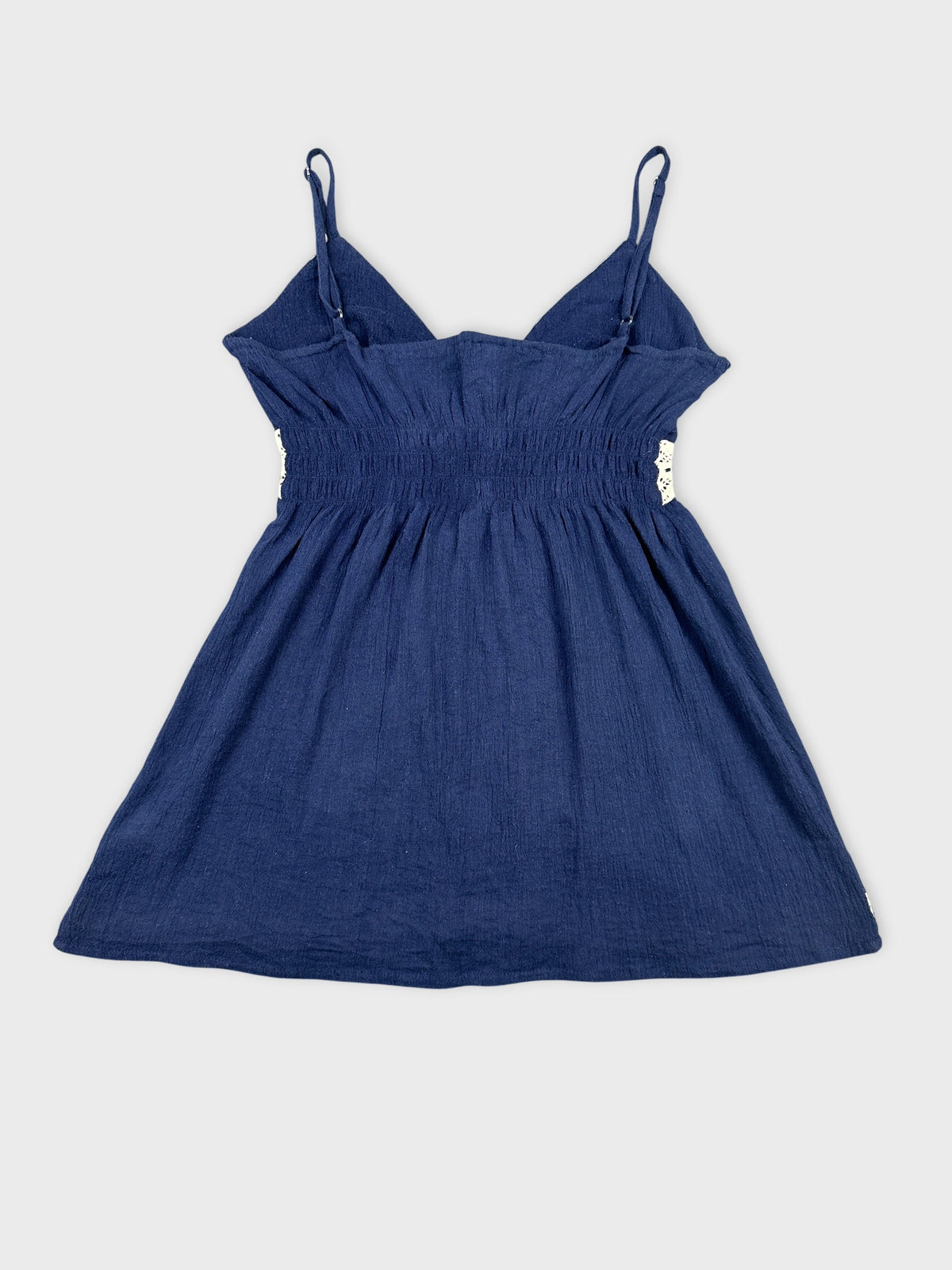 Back view of a navy blue women's top featuring adjustable straps.