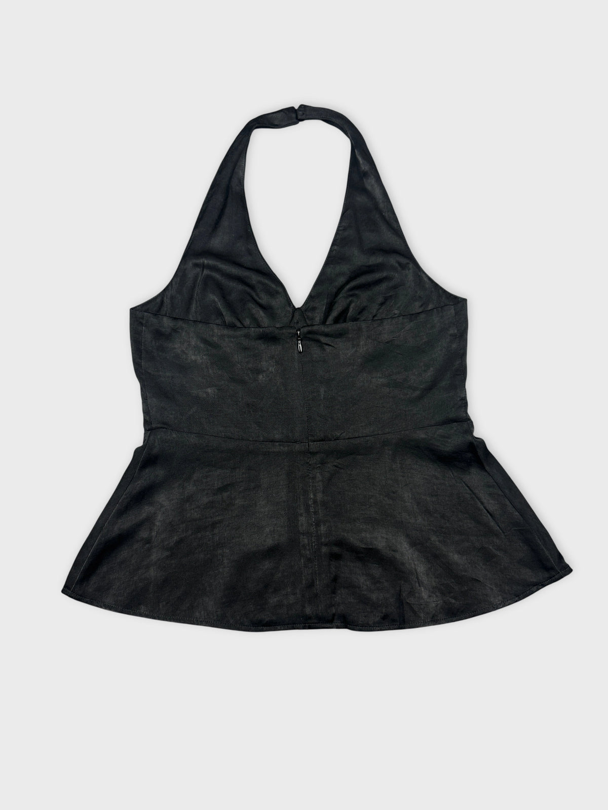 Back view of a black halter top with a fitted peplum shape.