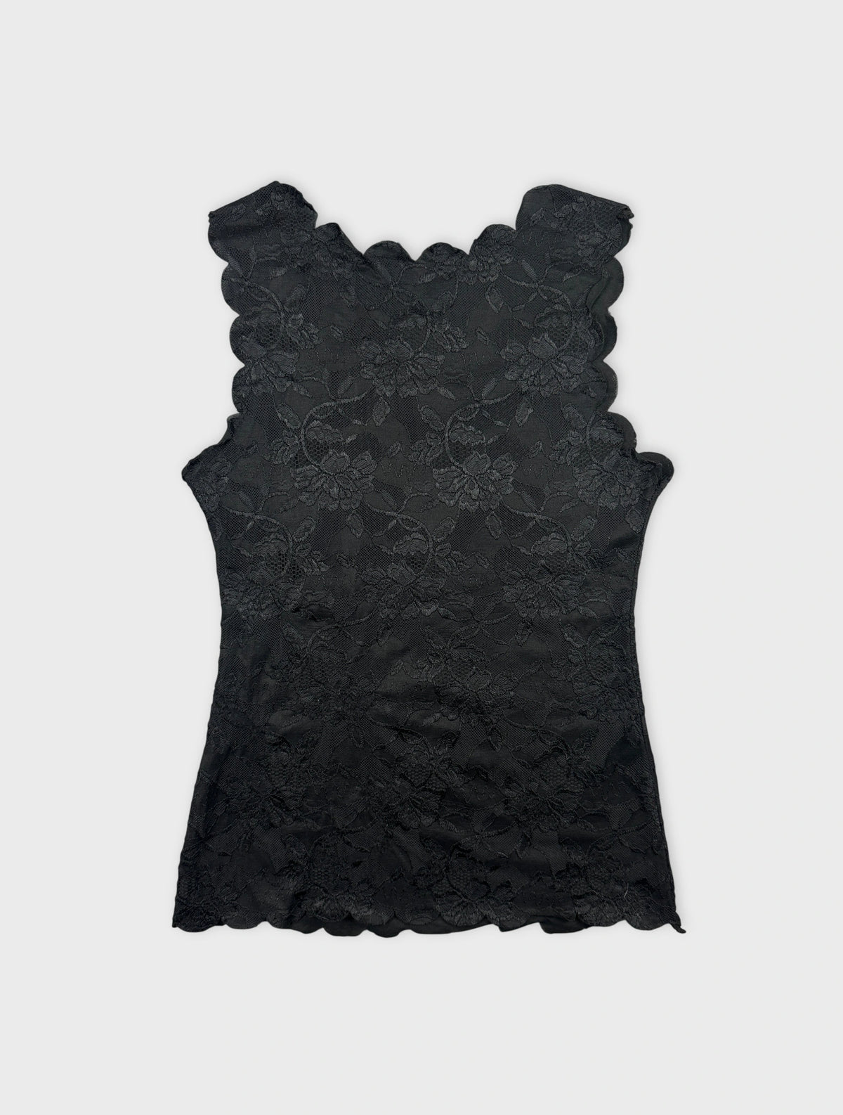 Back view of a black lace top with scalloped edges.