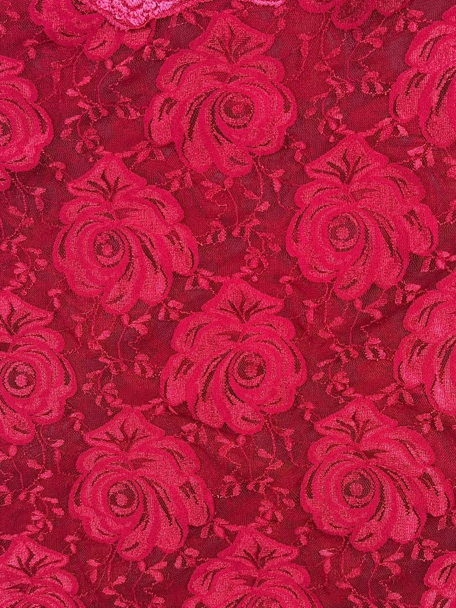 Detail view of red floral lace top with rose pattern.
