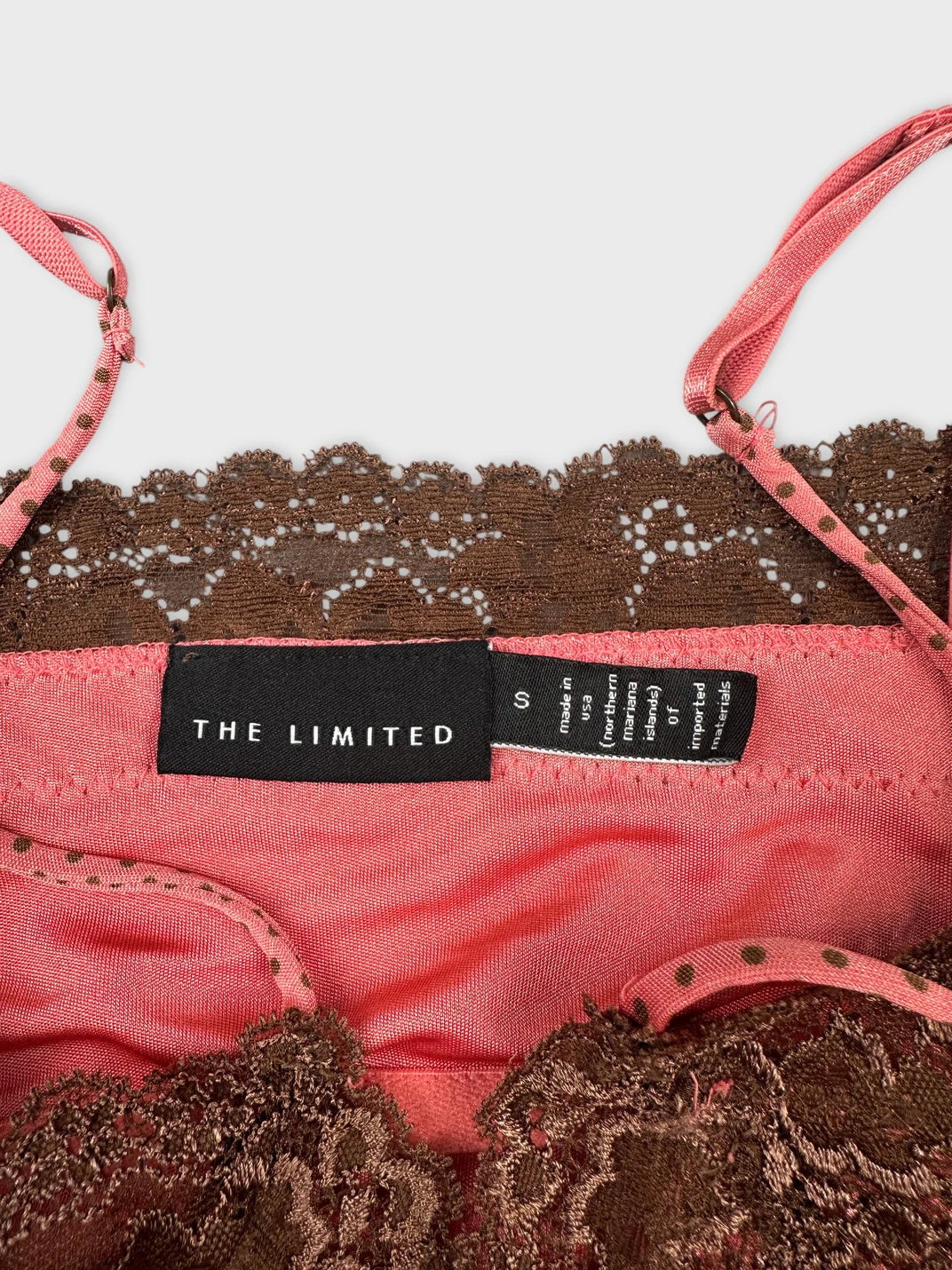 Detail view of a pink and brown lace trim top with adjustable straps.