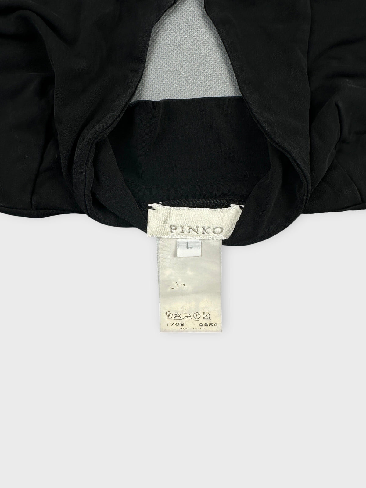 Detail view of a black upper body top featuring a mesh panel.