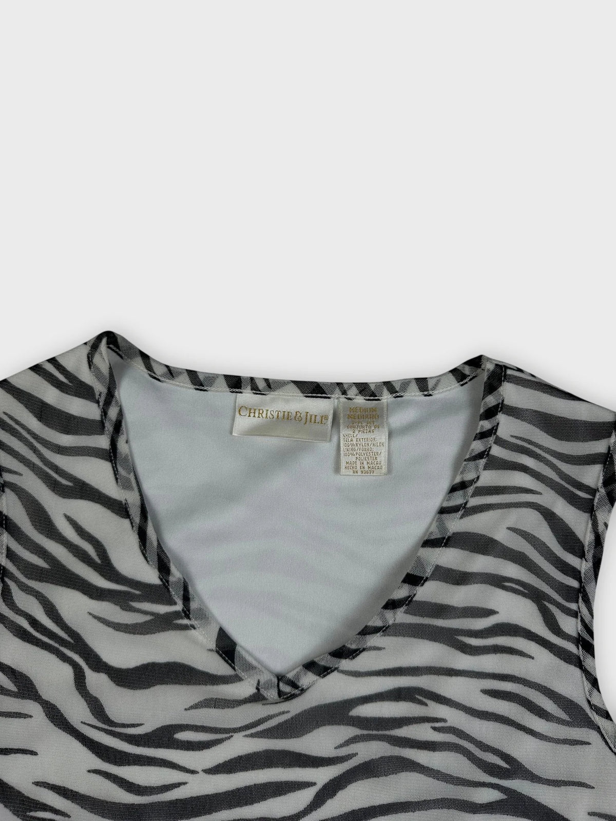 Detail view of a women's top featuring a black and white zebra print pattern.