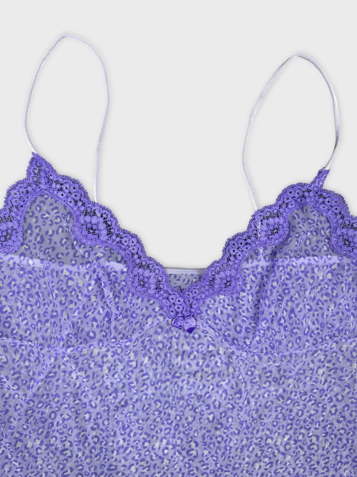Detail view of a lavender camisole with lace trim and leopard print.