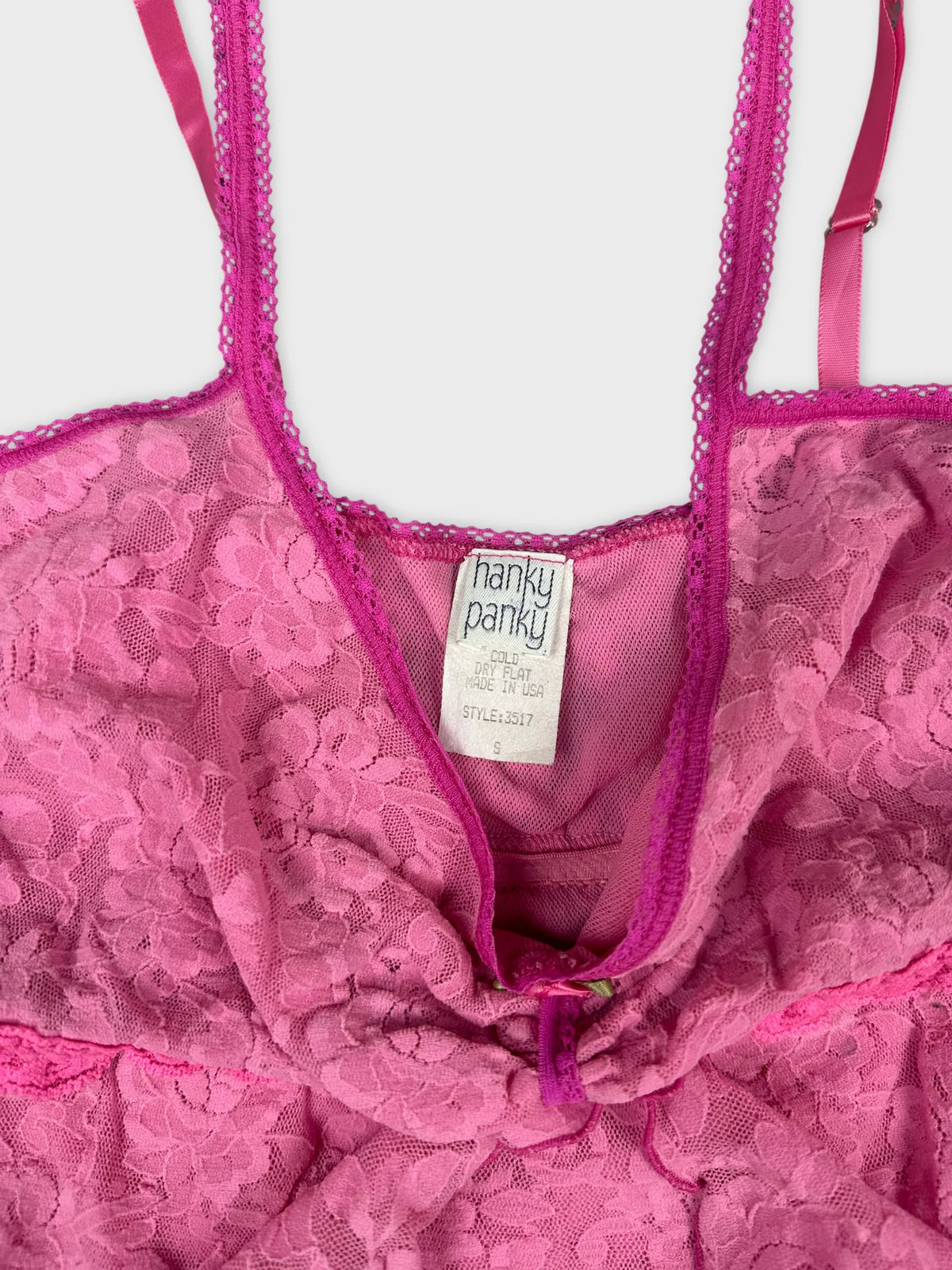 detail view of a pink lace women's top with adjustable straps