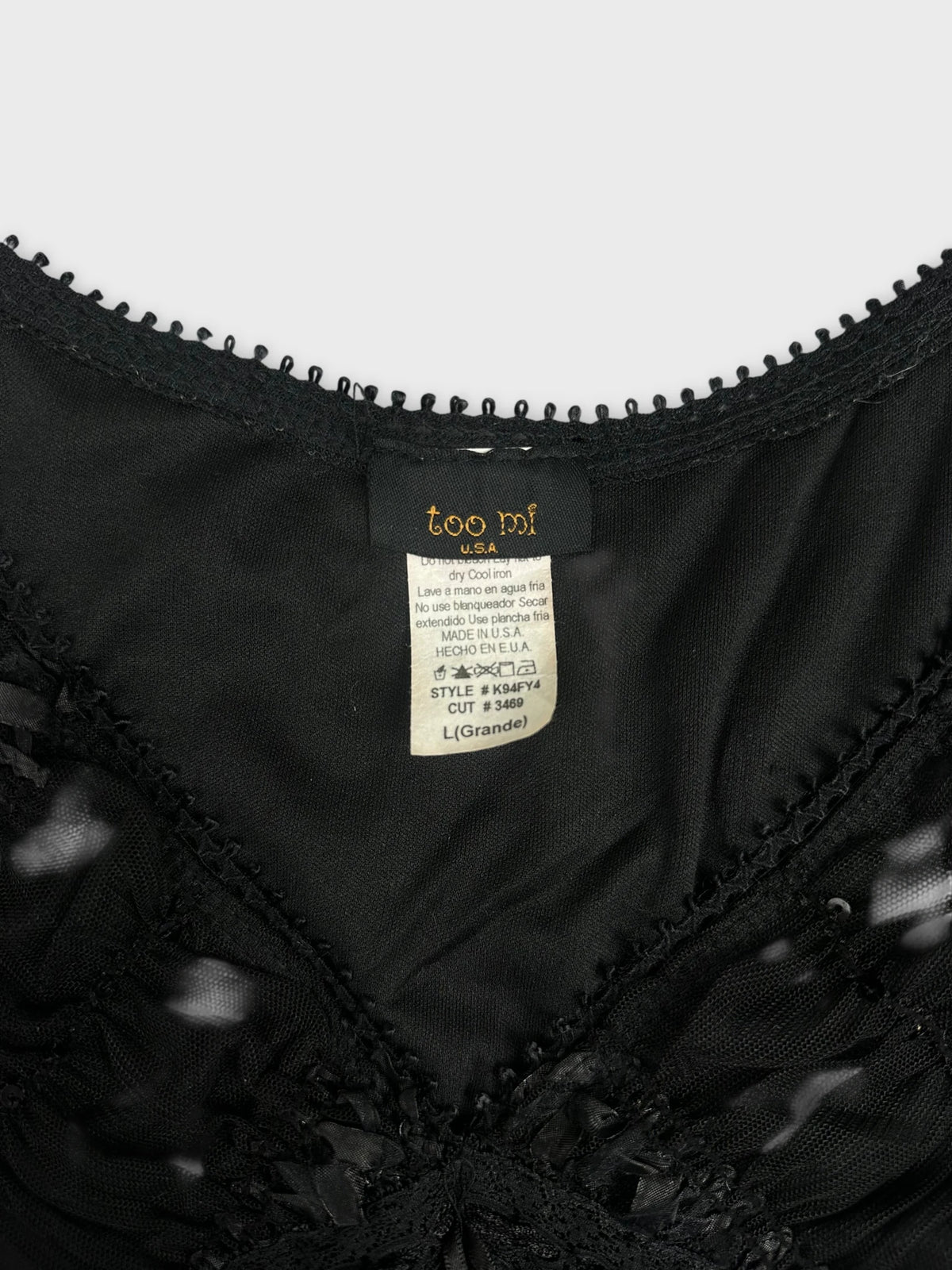 Black upper body top with lace trim detail view.