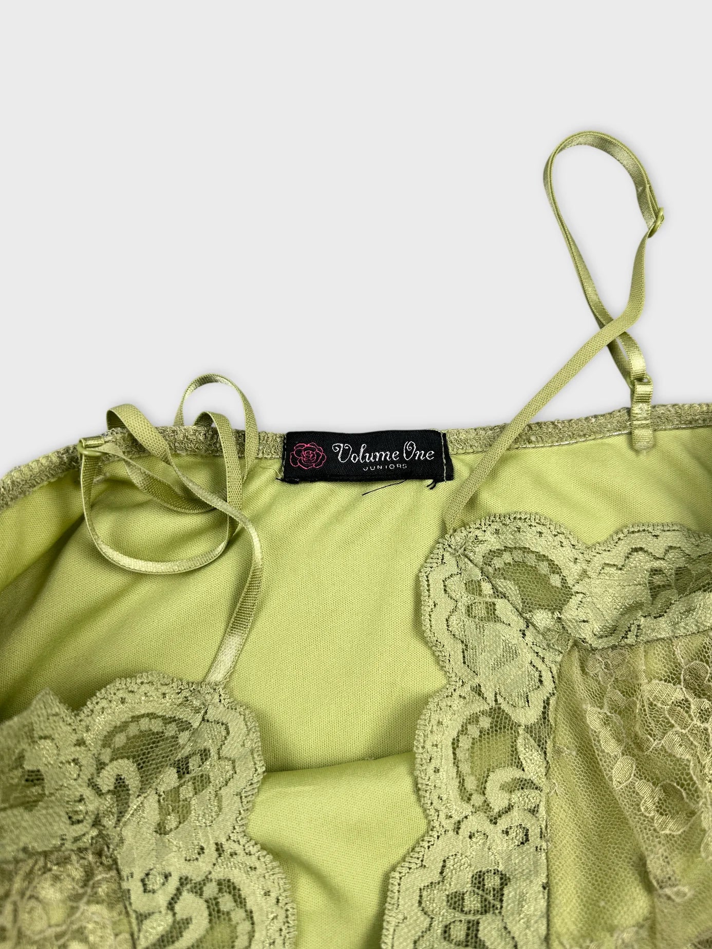 detail view of a light green vintage top with lace trim