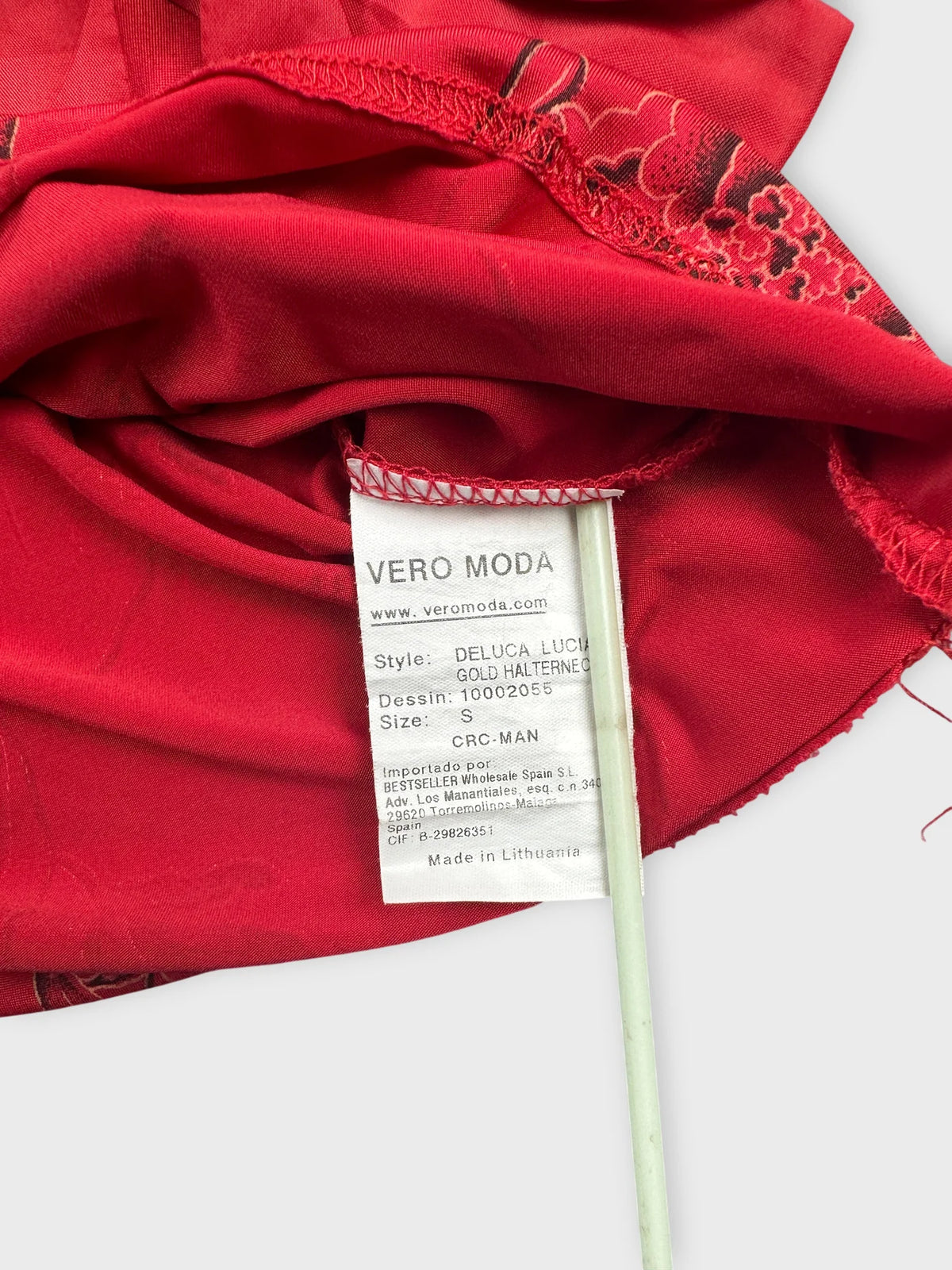 Detail view of a red vintage upper body top featuring floral print.