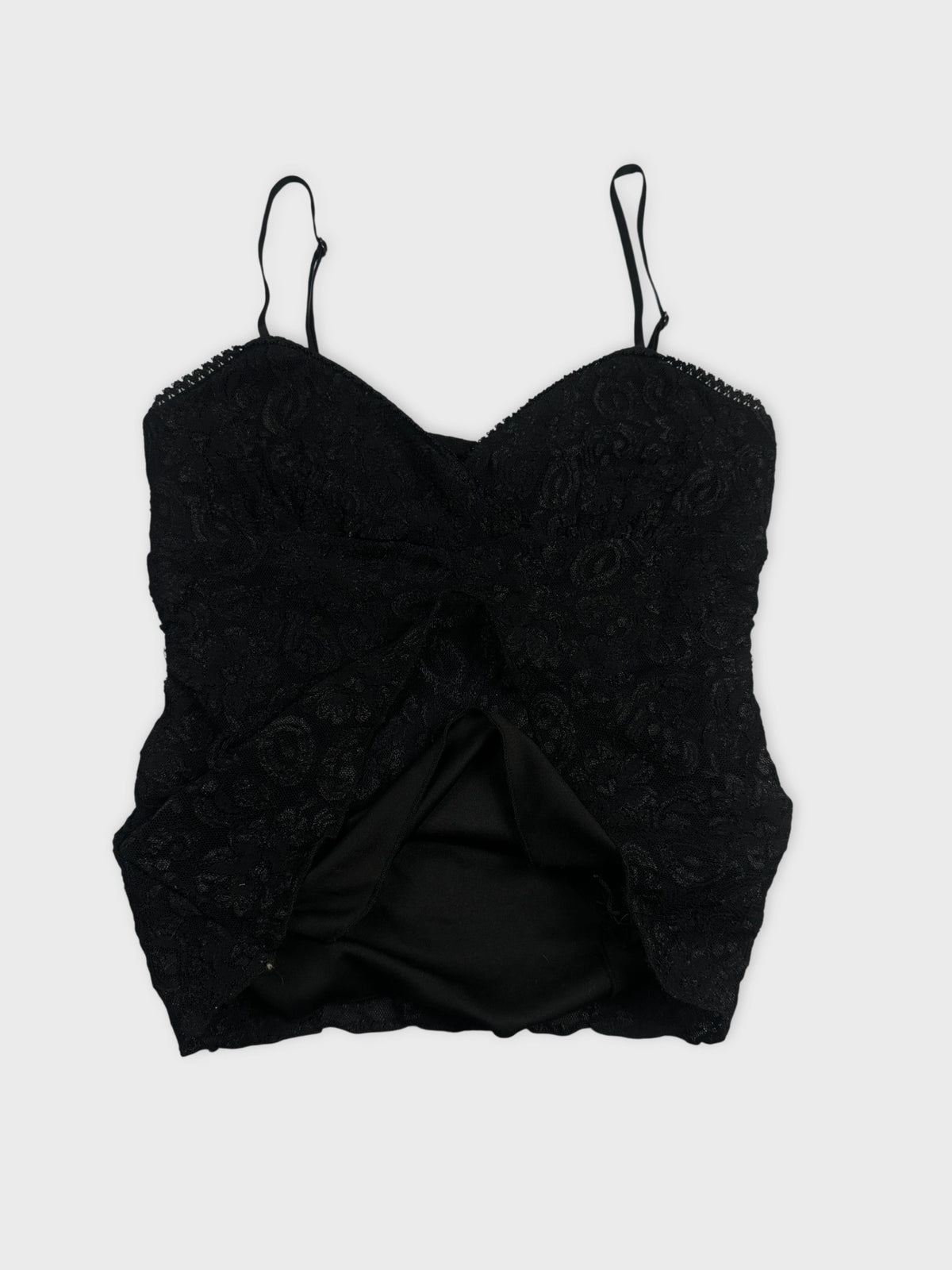 Detail view of a black lace women’s top with thin straps.