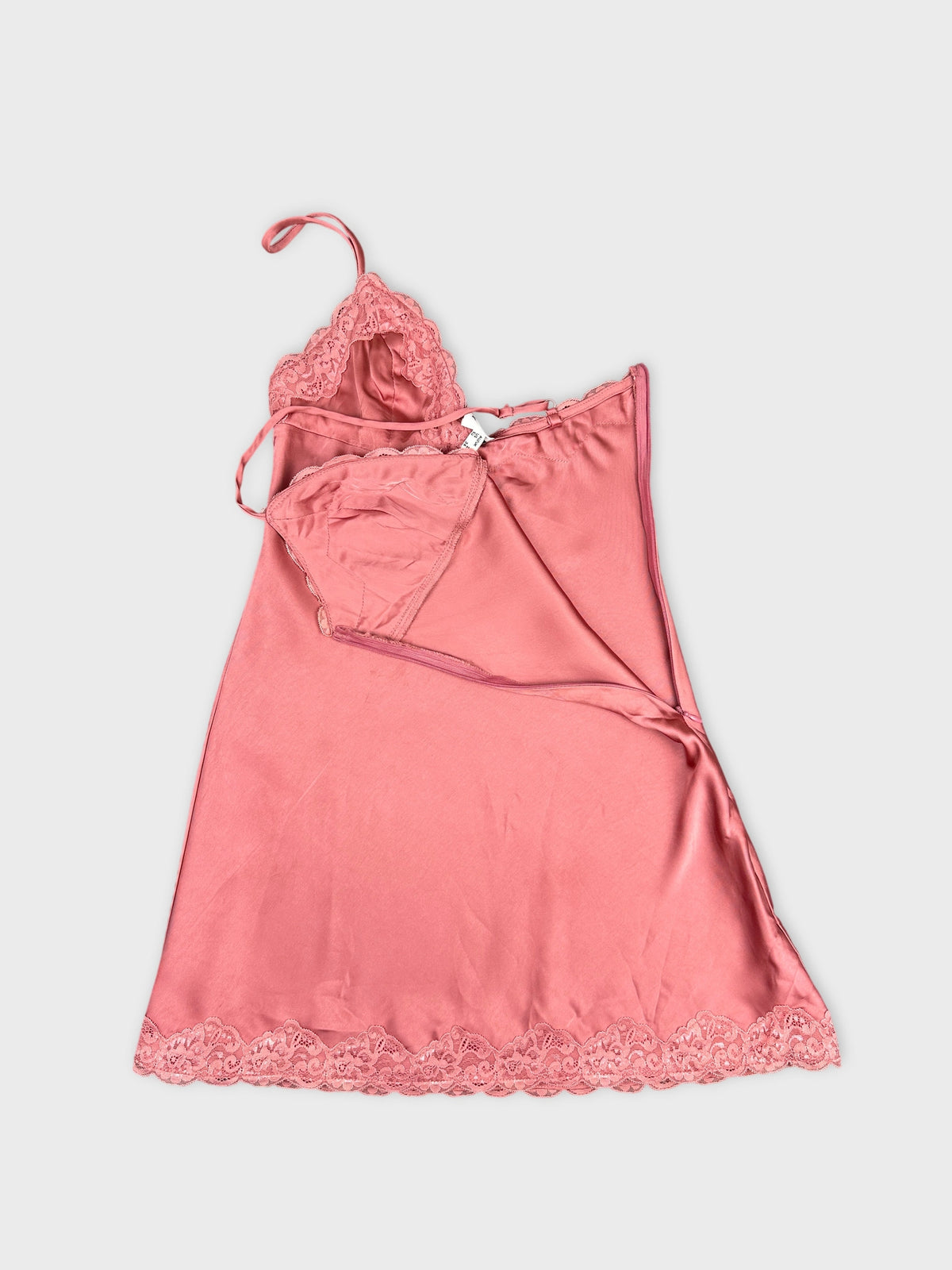 Detail view of a pink women's top featuring lace trim.