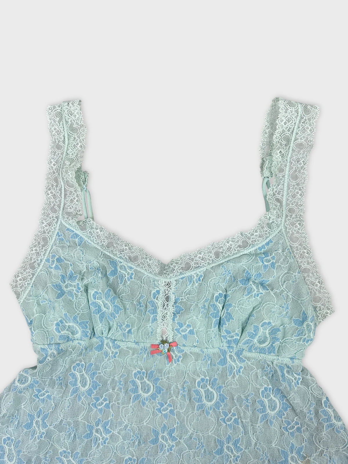 Detail view of a light blue lace women's tank top featuring floral patterns.