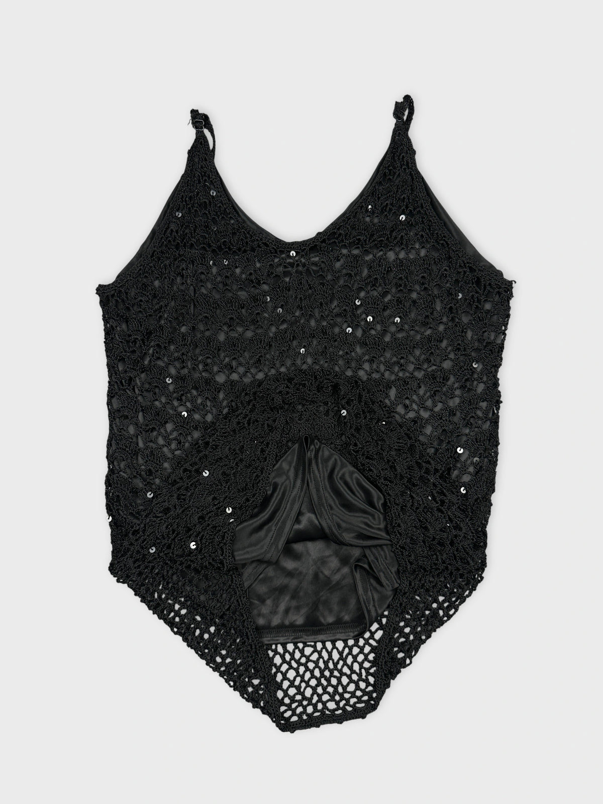 detail view of a black crochet top with sequins