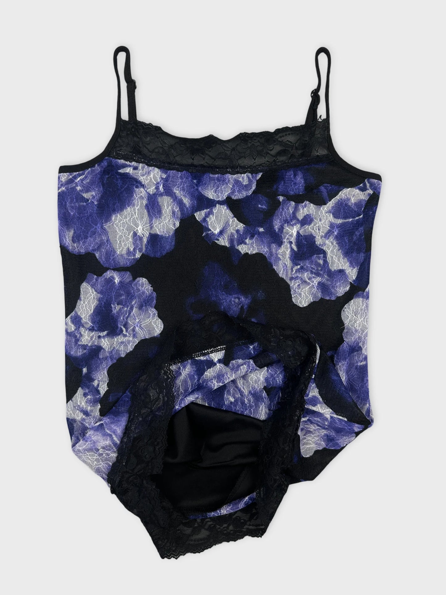 Detail view of a black and blue floral top with lace trim.
