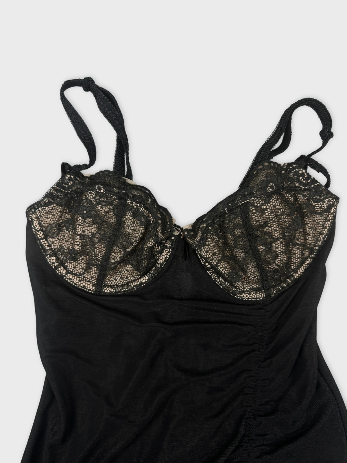 Black top with lace detailing in a detail view