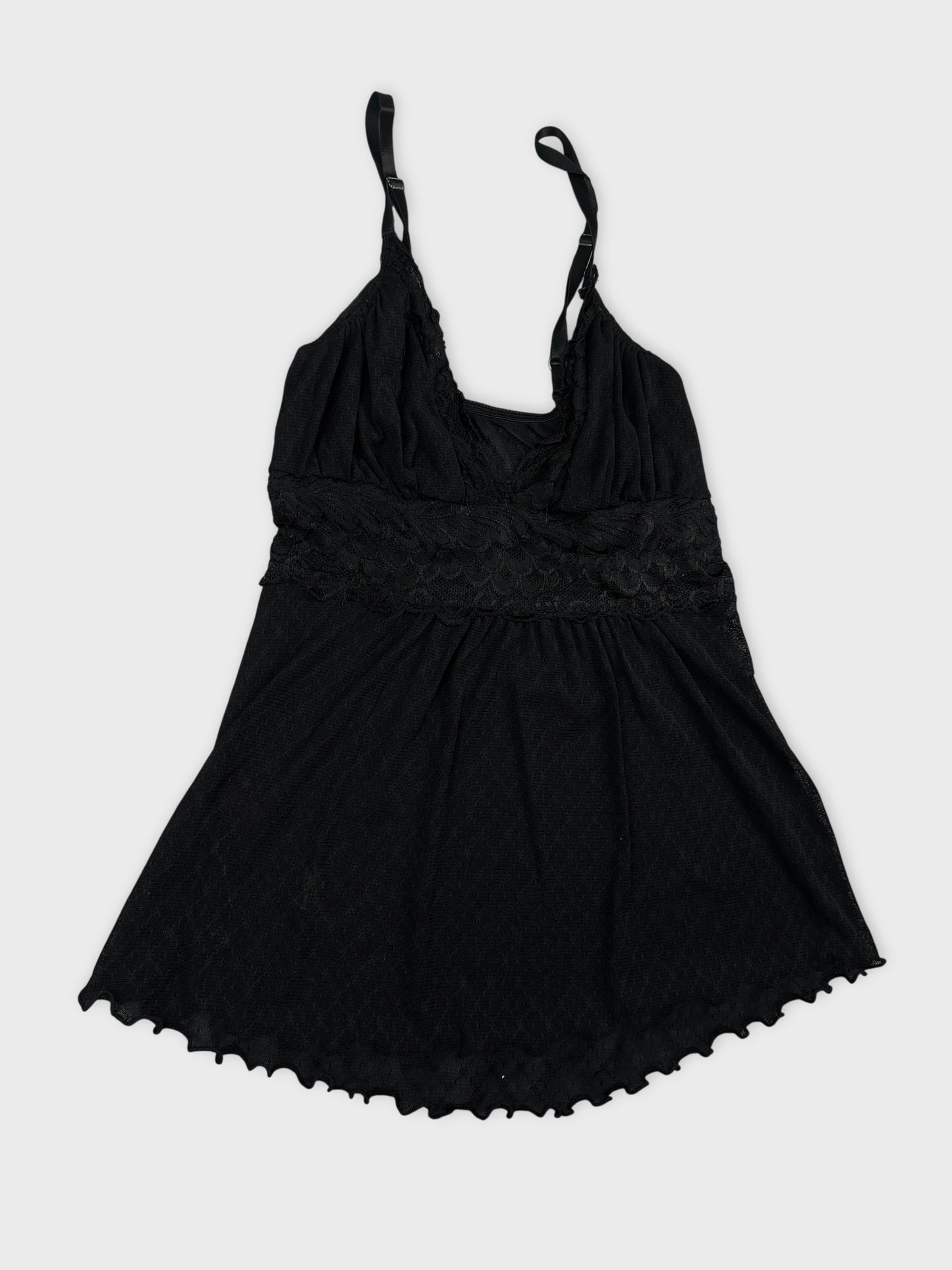 Detail view of a black women's top with lace trim and adjustable straps.