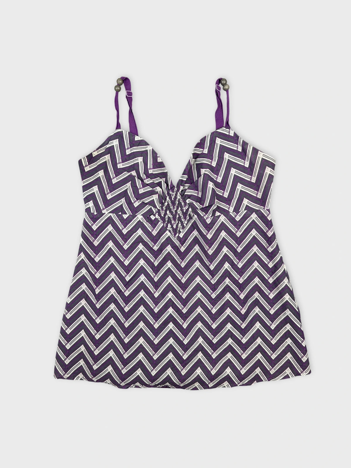 Detail view of a purple chevron-patterned women’s top with thin straps.