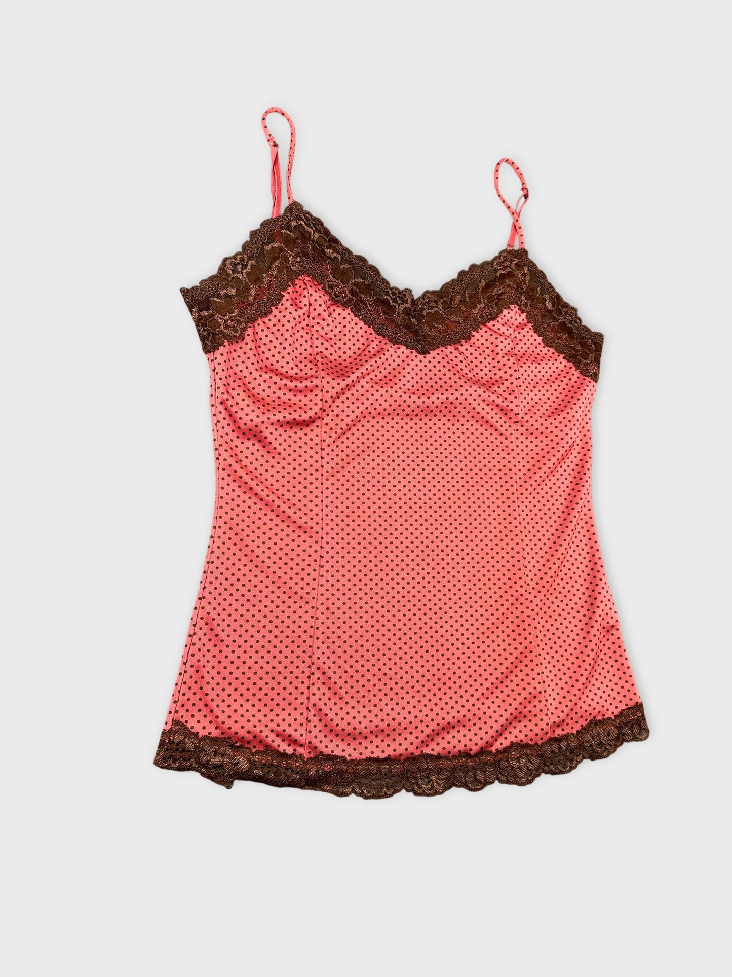 Detail view of a pink polka dot camisole with chocolate lace trim.