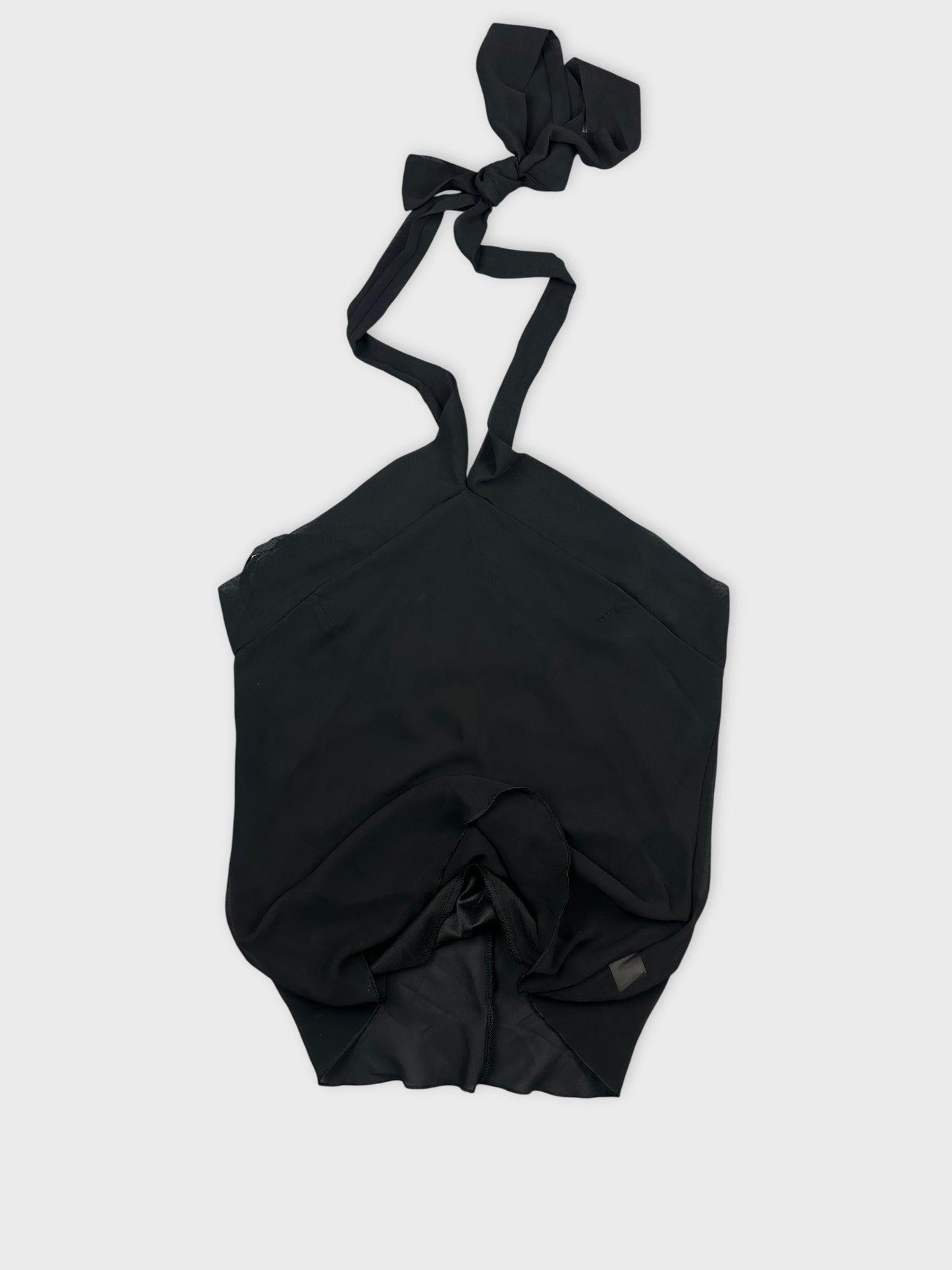 Detail view of a black upper body top featuring a tied strap design.