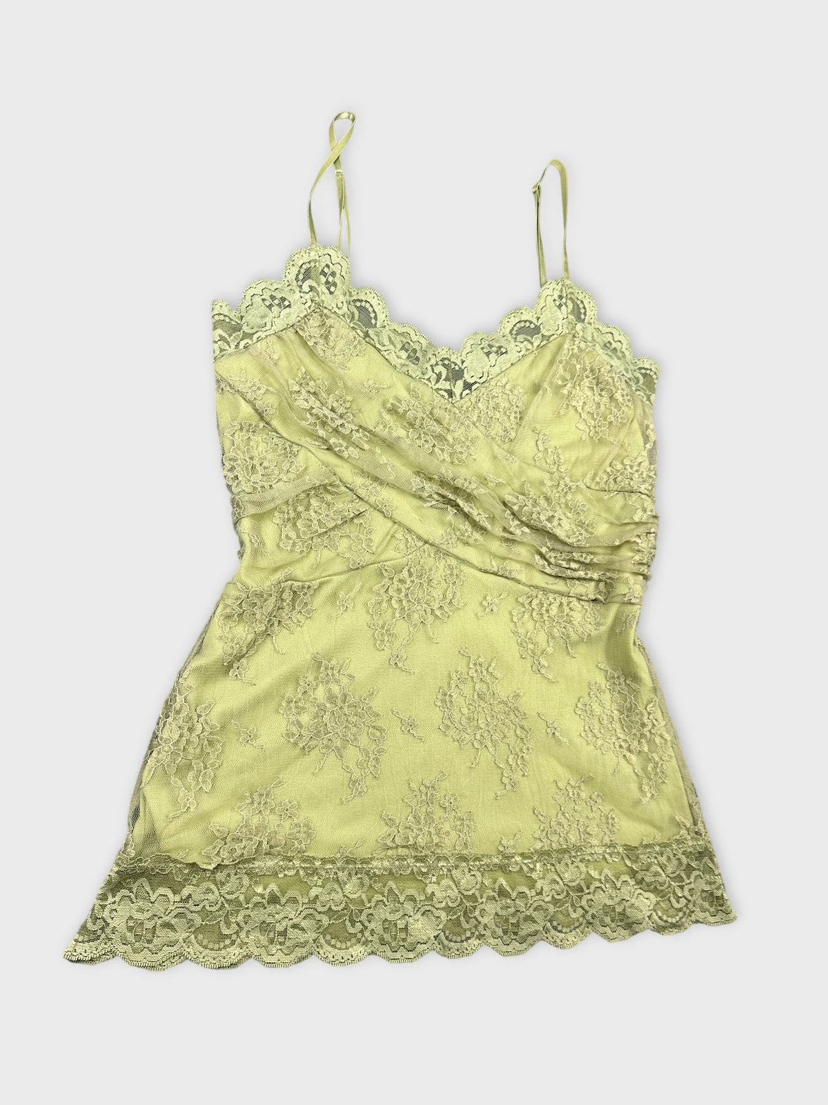 detail view of a light green lace camisole top with floral pattern